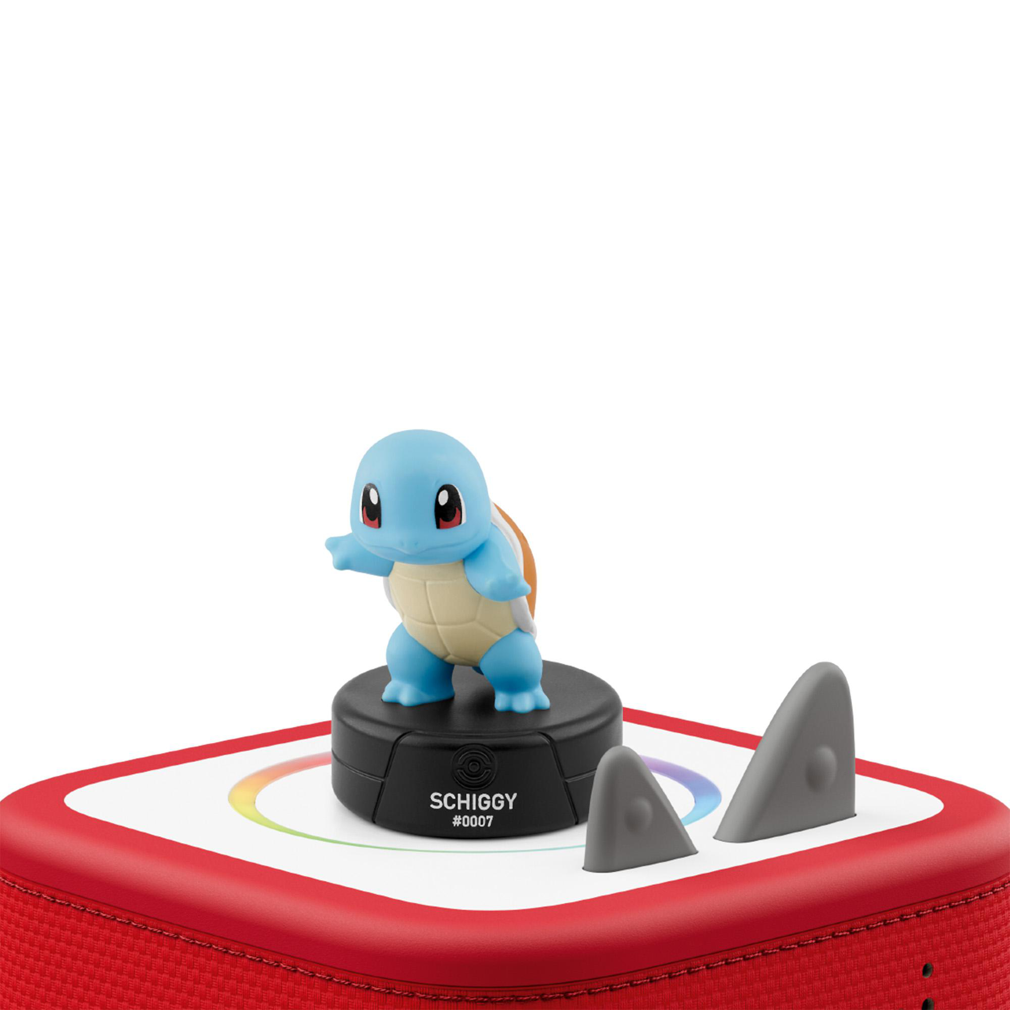 Eine Blaue Squirtle Figur auf einer runden Basis, stehend auf einem rot-weißen Gerät vor weißem Hintergrund.