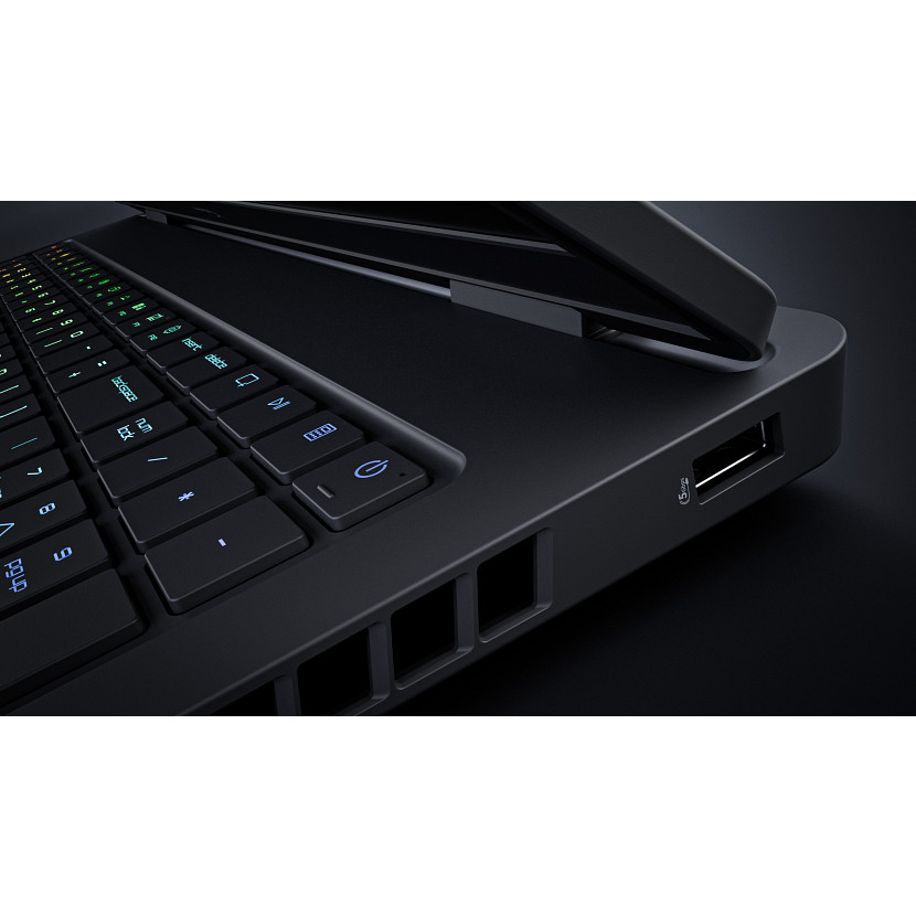 Nahaufnahme einer schwarzen Laptoptastatur mit beleuchteten Tasten, USB-Anschluss und Lüftungsschlitzen.