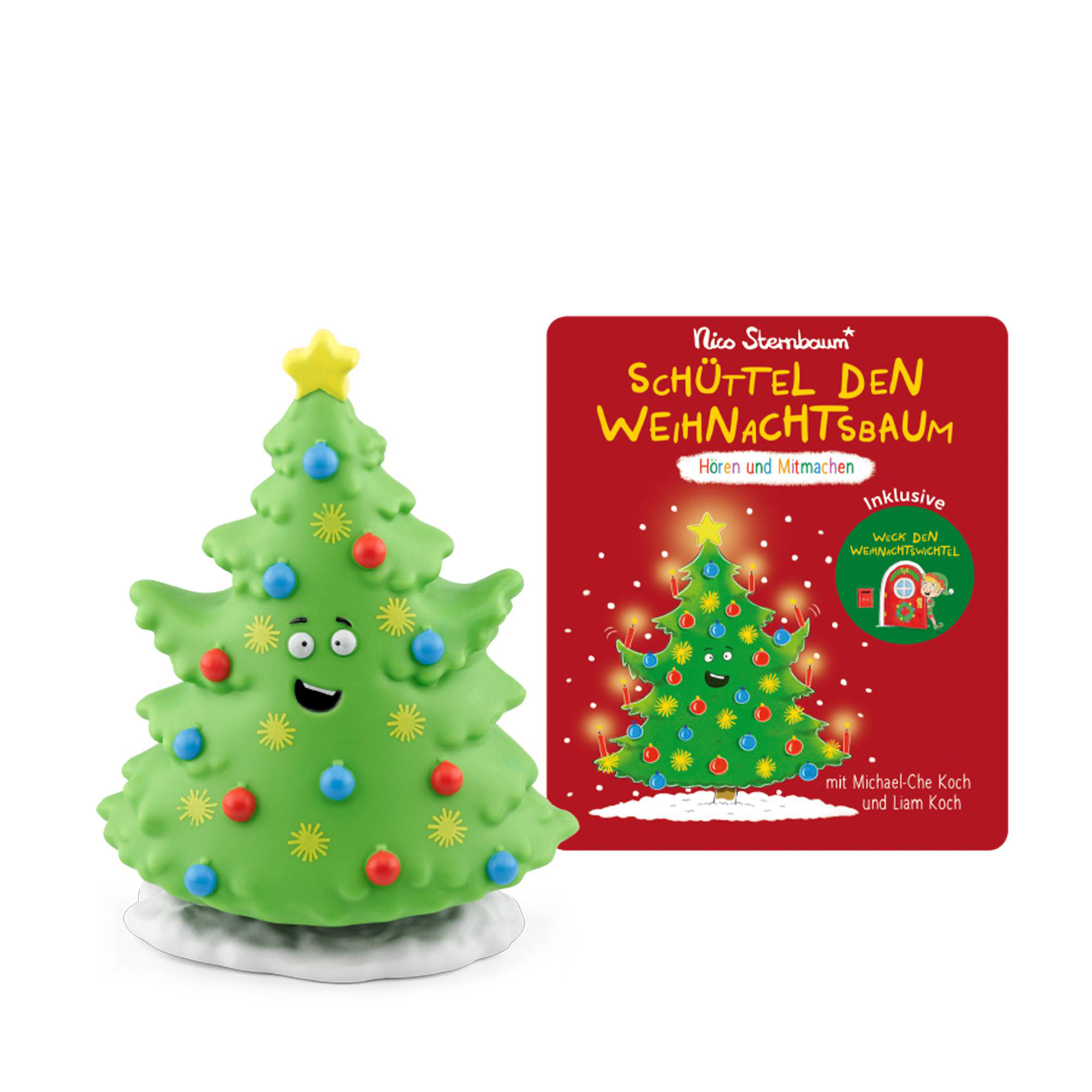 Ein grüner, lächelnder Weihnachtsbaum aus Plastik steht neben einem roten Kinderbuch mit dem Titel "Schüttel den Weihnachtsbaum".