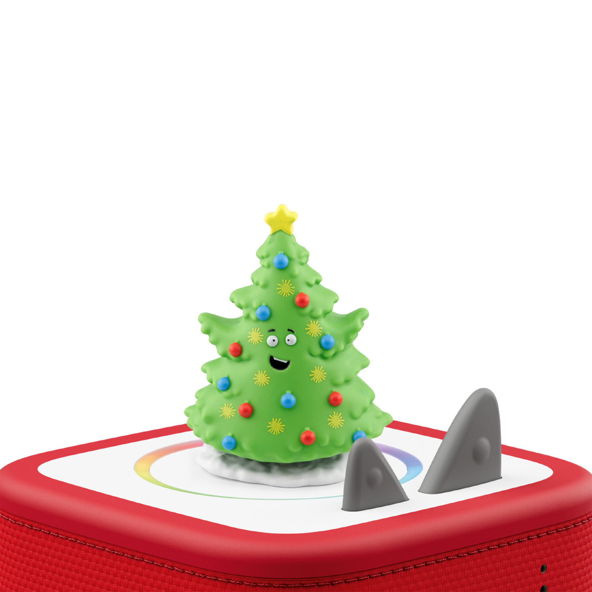 Ein grüner Weihnachtsbaum mit einem fröhlichen Gesicht steht auf einem roten Lautsprecher.