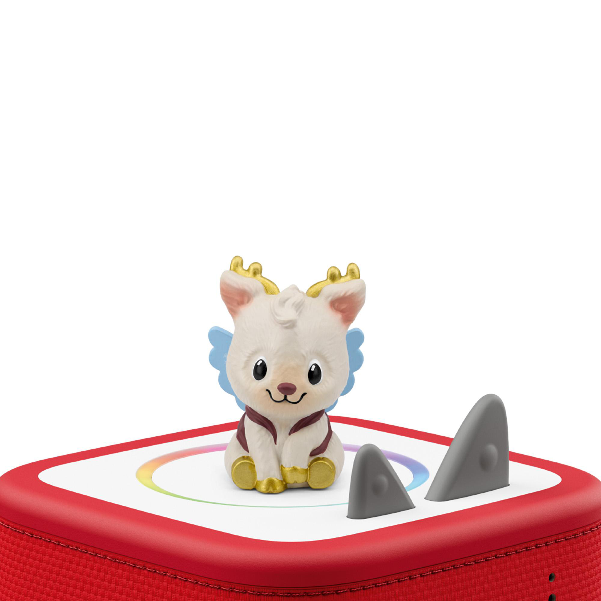 Eine kleine weiße Hirschfigur mit goldenem Geweih sitzt auf einem roten Musikbox-Gerät mit bunten Lichtern.