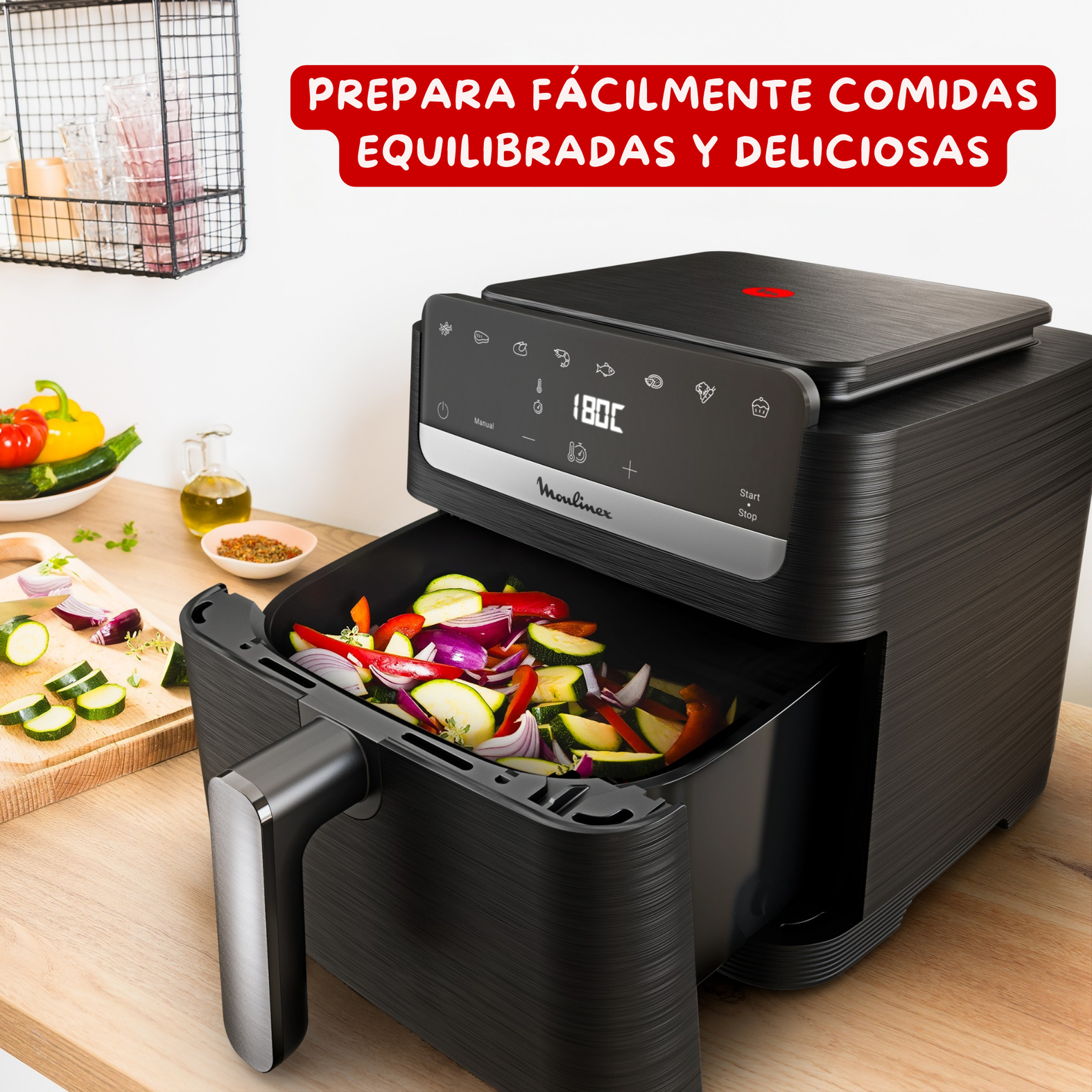 Freidora de aire negra Moulinex sobre encimera de madera, llena de verduras picadas, con texto en espanol arriba.