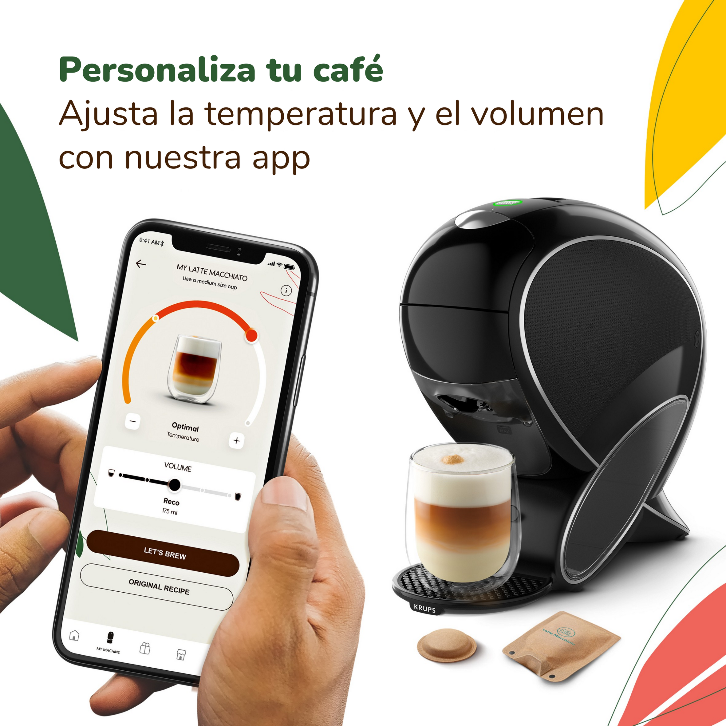 Un smartphone muestra una app de café junto a una cafetera KRUPS negra y un vaso de latte macchiato.