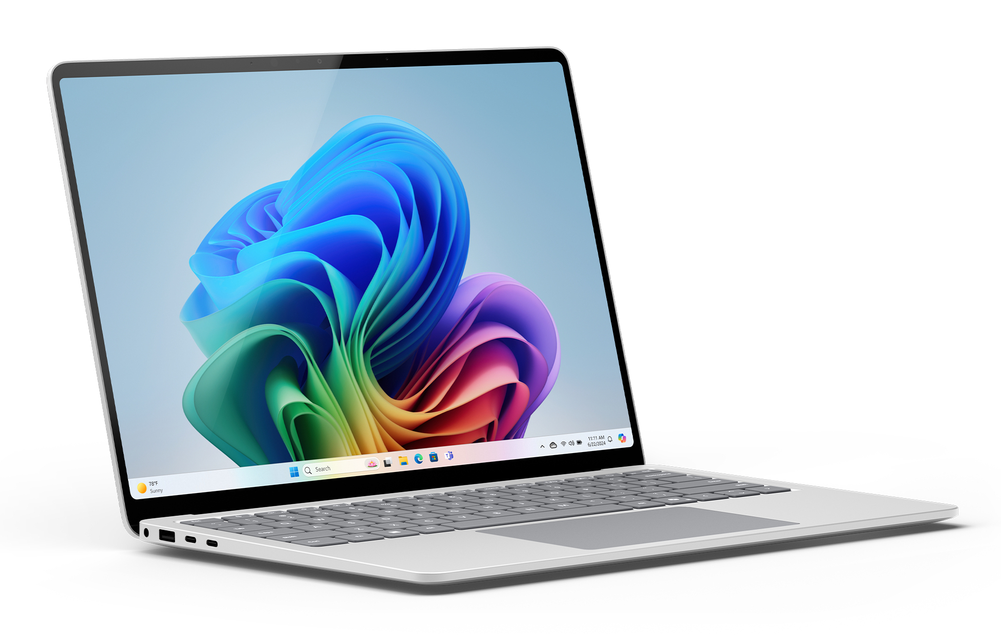 Ein silberner Laptop mit einem bunten Windows-11-Hintergrundbild steht auf einer weißen Oberfläche.