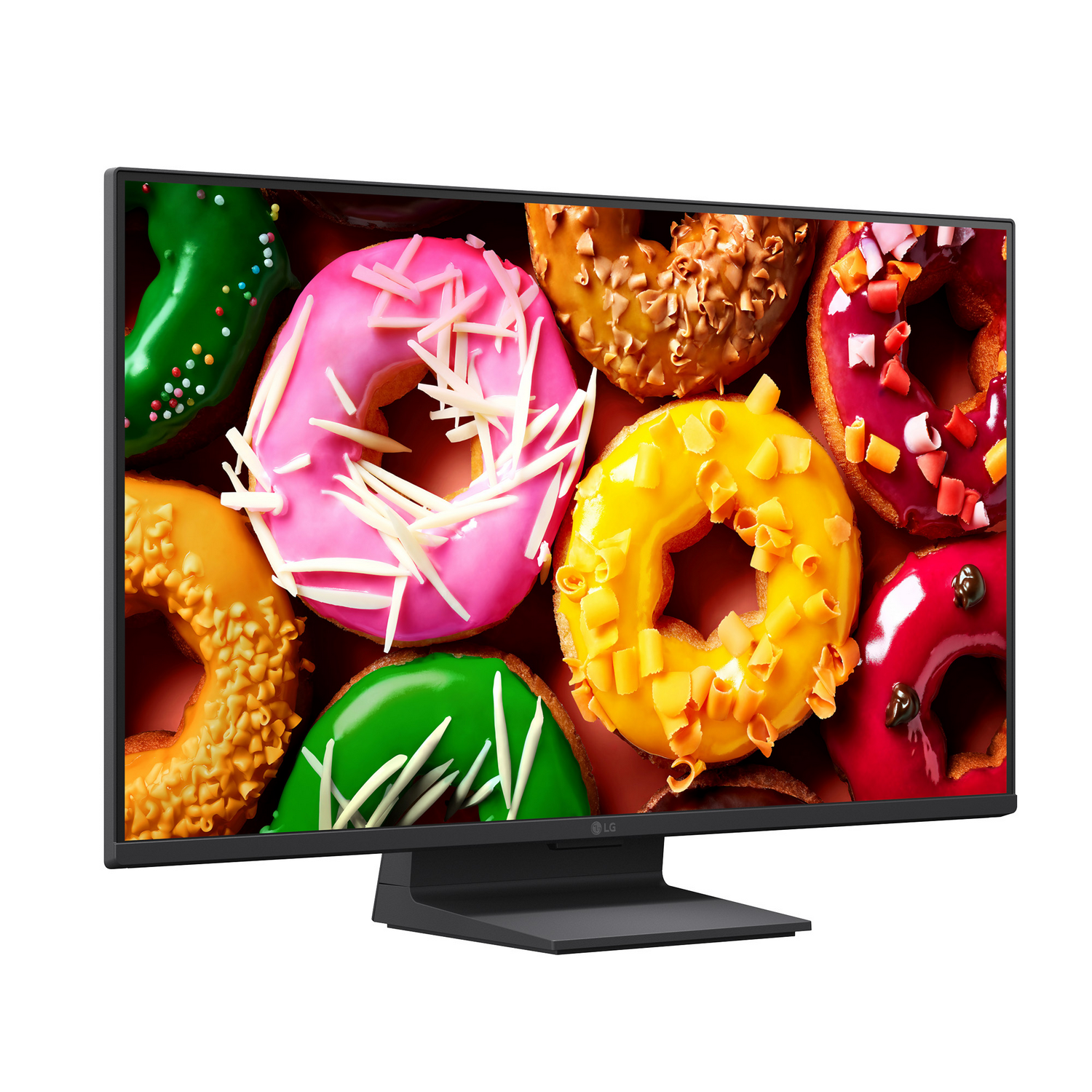Un monitor negro muestra un fondo colorido de varios donuts glaseados y decorados.