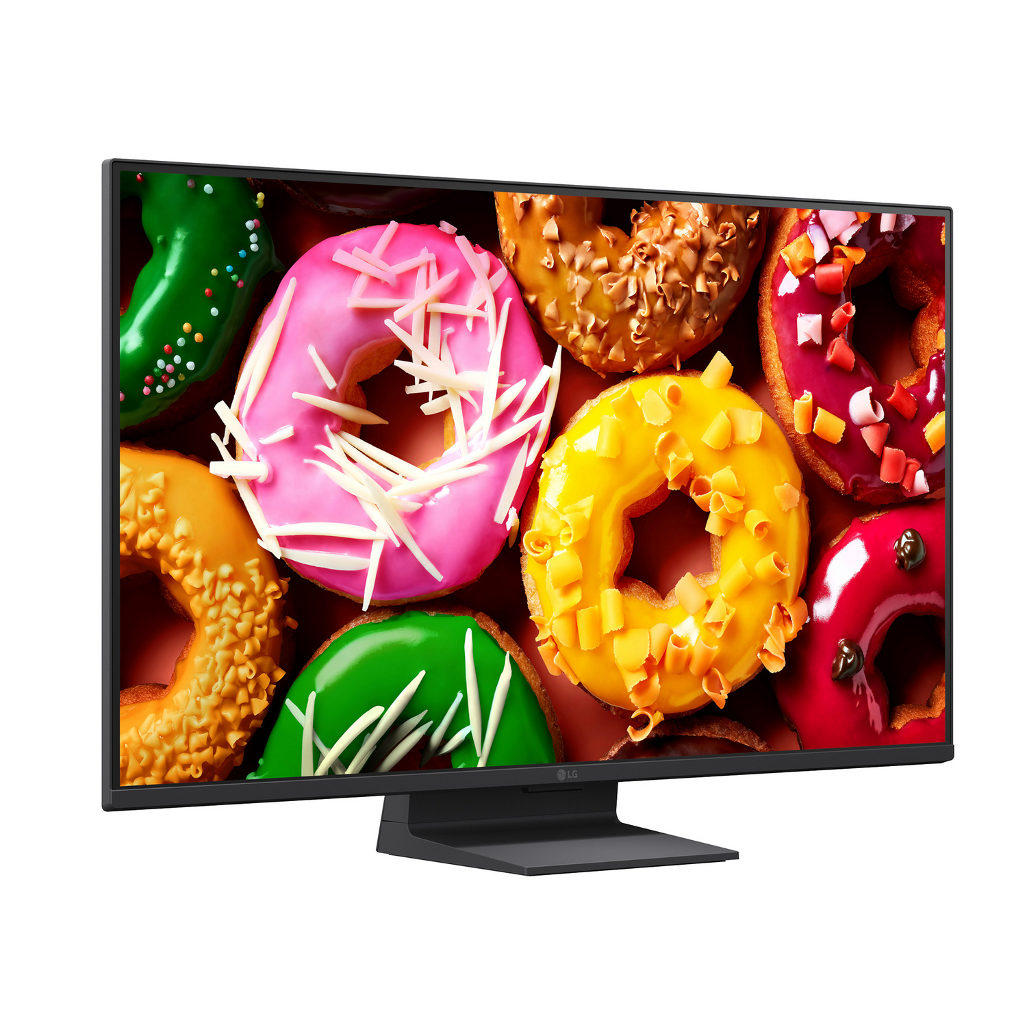 Un monitor negro muestra una imagen brillante y colorida de varios donuts glaseados sobre un fondo rojo.