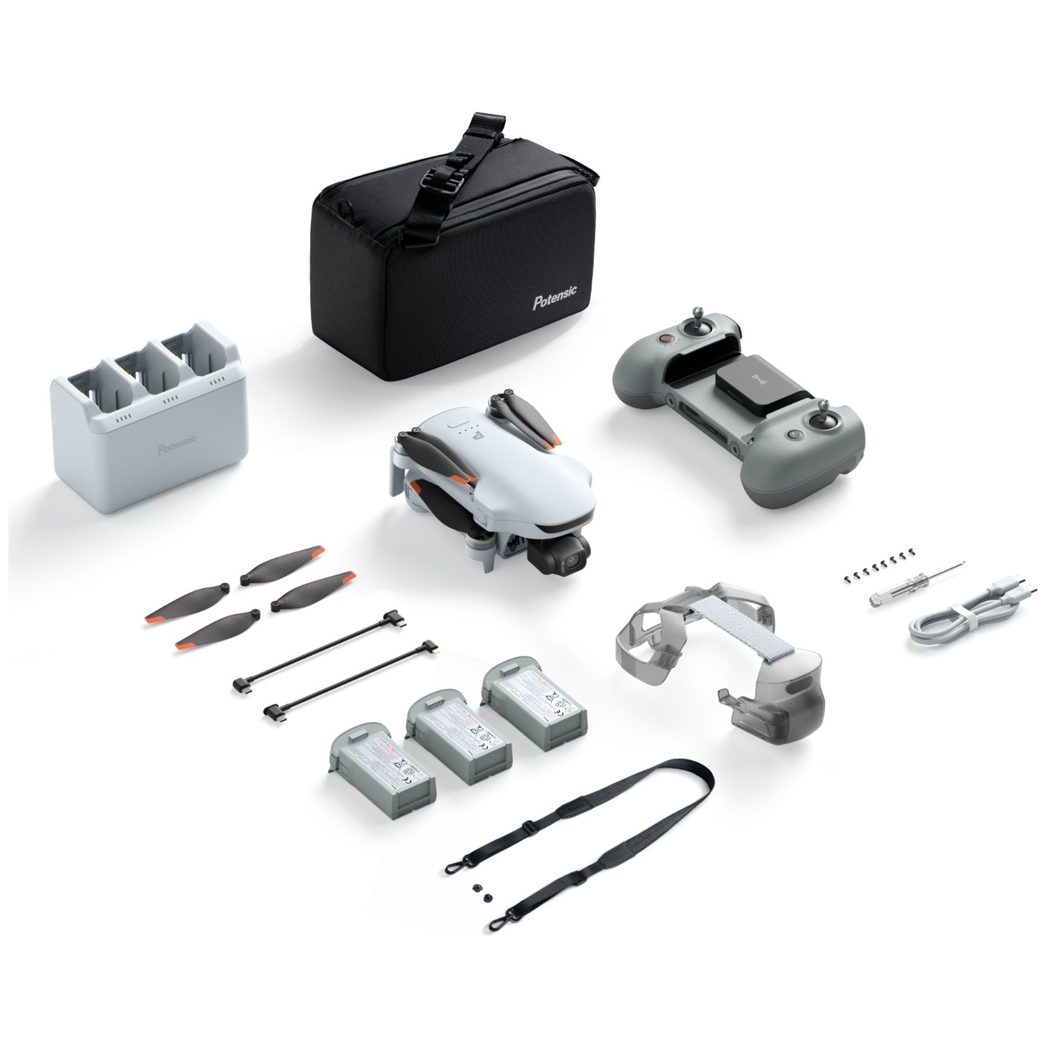 Un drone gris avec sac, télécommande, batteries, chargeur, hélices et accessoires sur fond blanc.