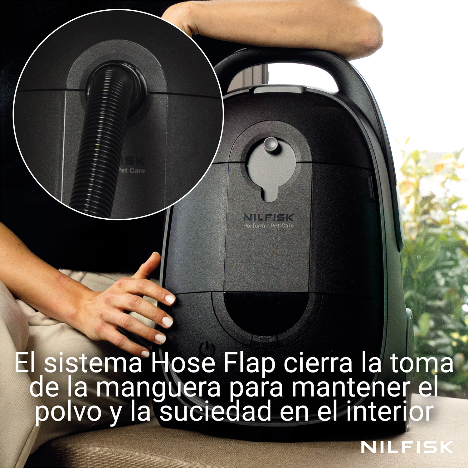 Aspiradora Nilfisk negra con sistema Hose Flap que cierra la toma de manguera para retener la suciedad.
