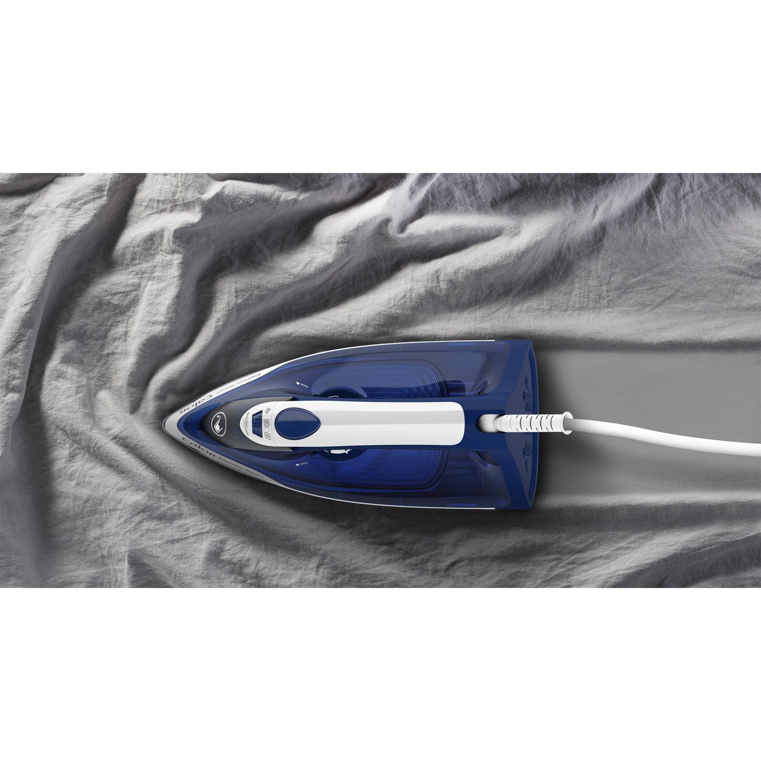 A blue and white iron glides over grey fabric, smoothing it out.