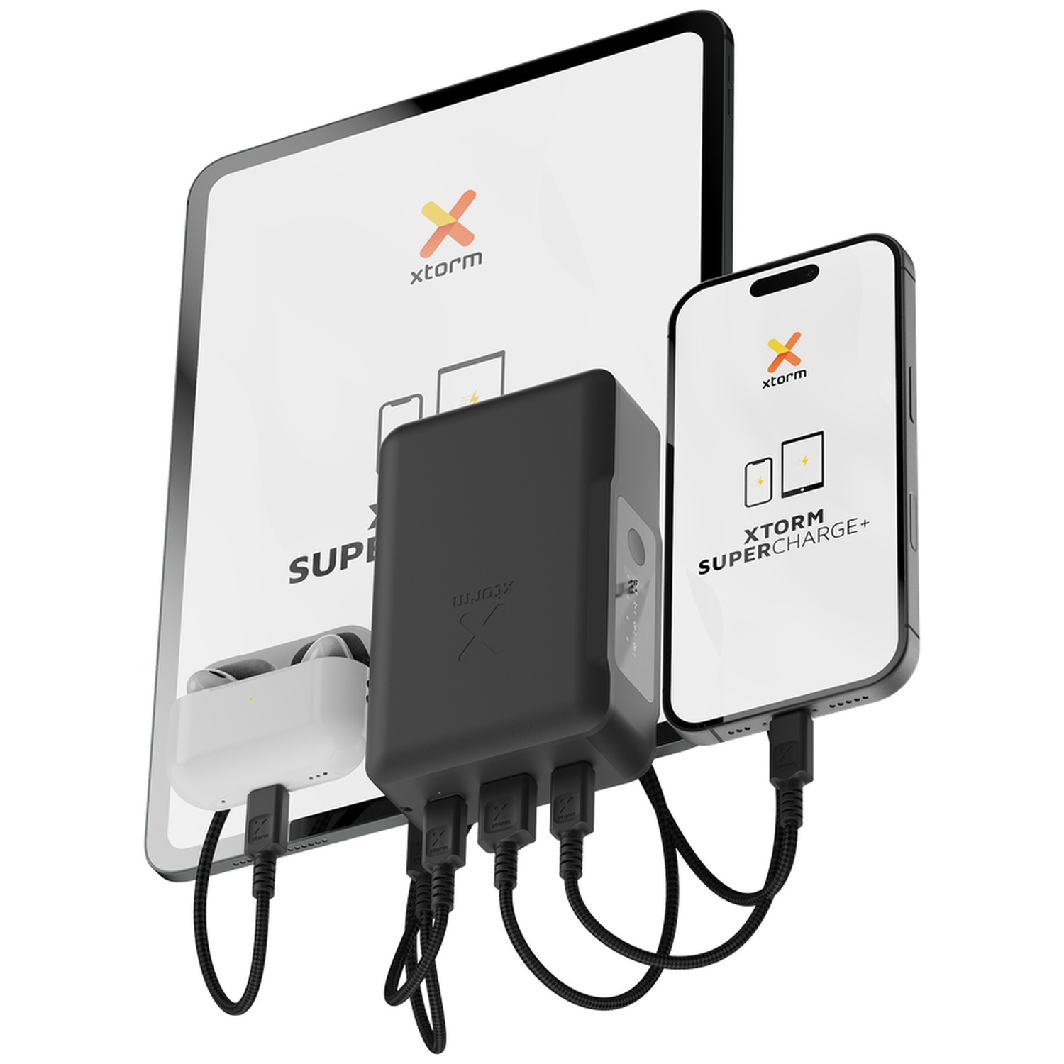 Une batterie externe noire charge une tablette, un smartphone et des écouteurs via des câbles noirs.