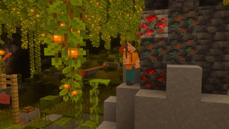 Minecraft-Figur steht in einer von hängenden Ranken und leuchtenden Erzen umgebenen Höhle.