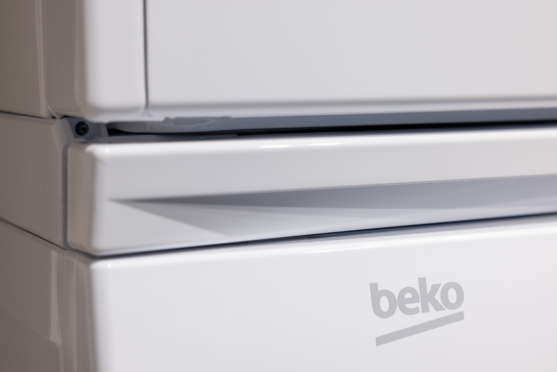 Zbliżenie białego urządzenia Beko z uchwytem i logo.