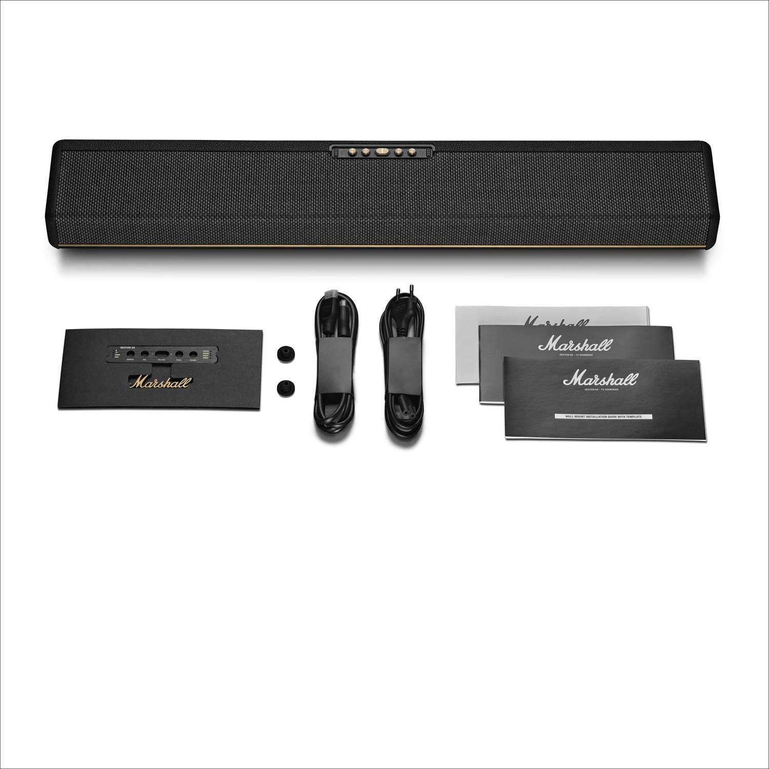Une barre de son Marshall noire avec ses câbles, son manuel et ses accessoires sur fond blanc.