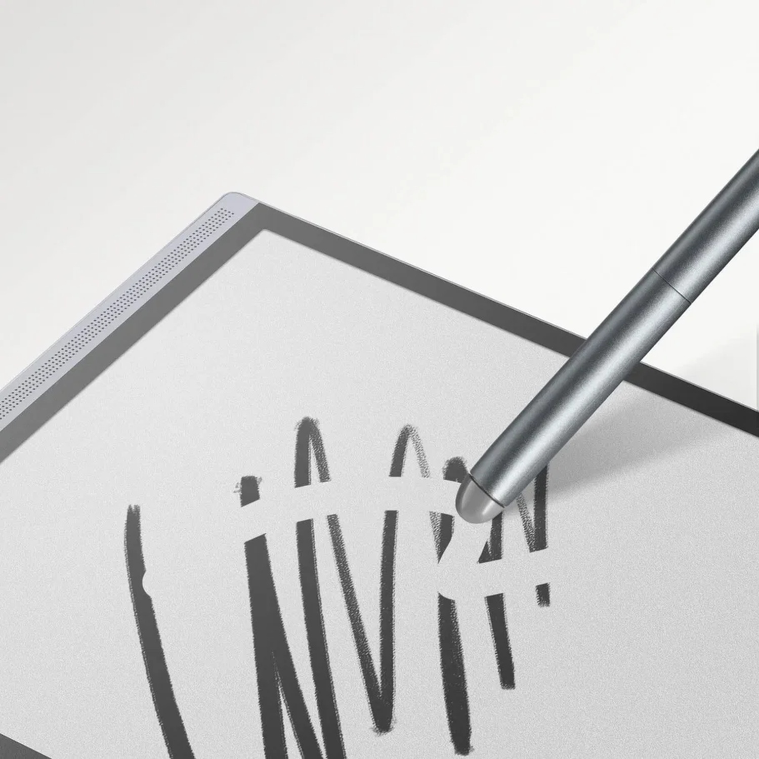A silver stylus writes on a digital tablet with black handwriting.