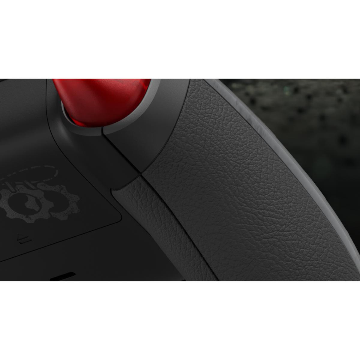 Nahaufnahme eines schwarz strukturierten Gamecontroller-Griffs mit rotem Stick und Zahnrad-Logo.