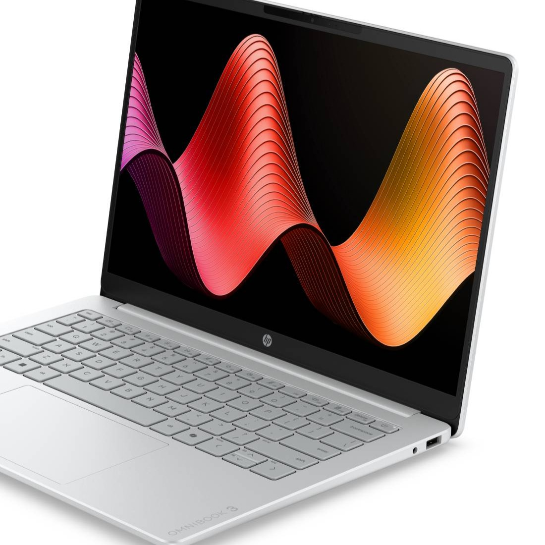 Un ordenador portátil HP plateado con un teclado elegante y un fondo de pantalla abstracto ondulado y colorido.