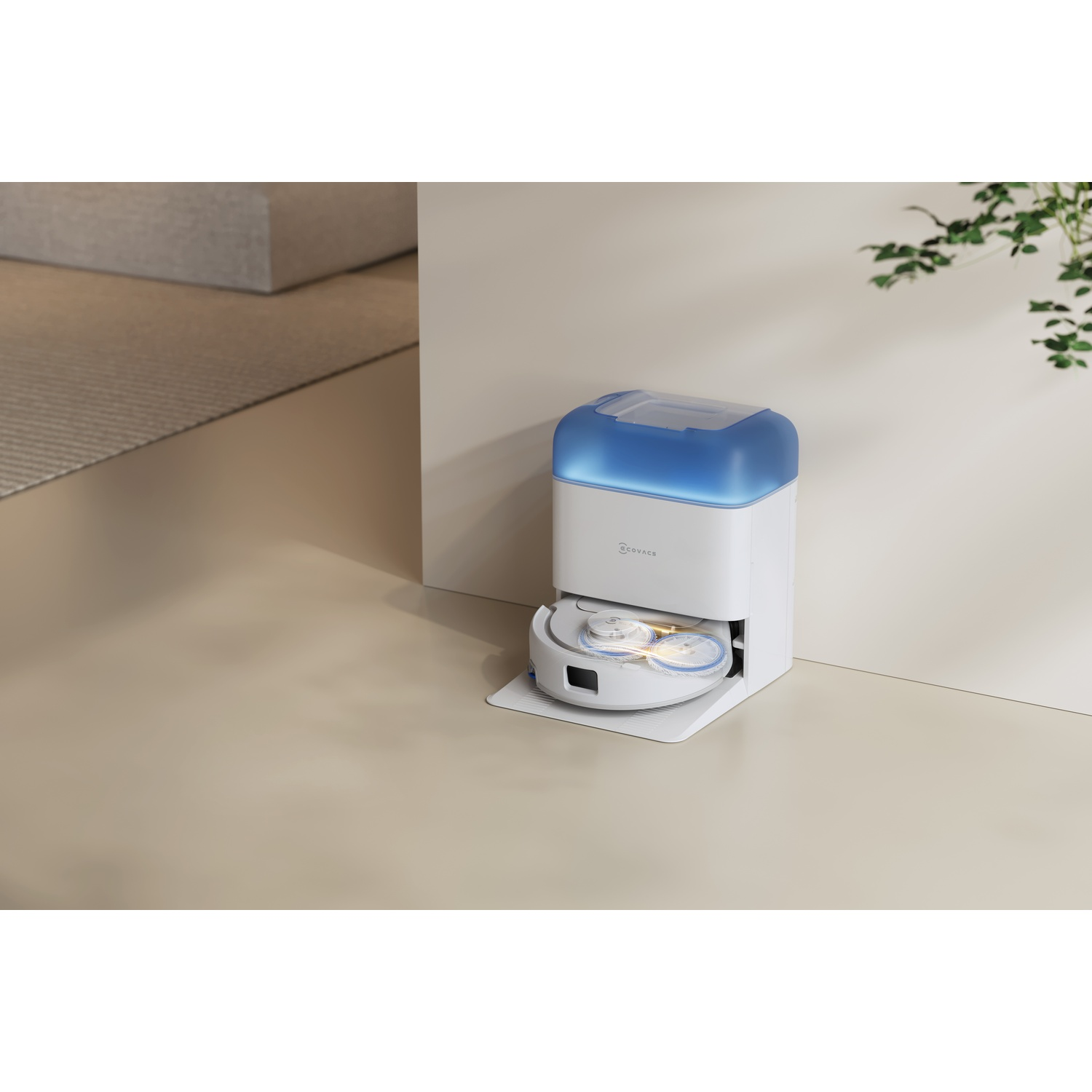 Un robot aspirapolvere bianco e blu nella sua base vicino a una parete chiara.