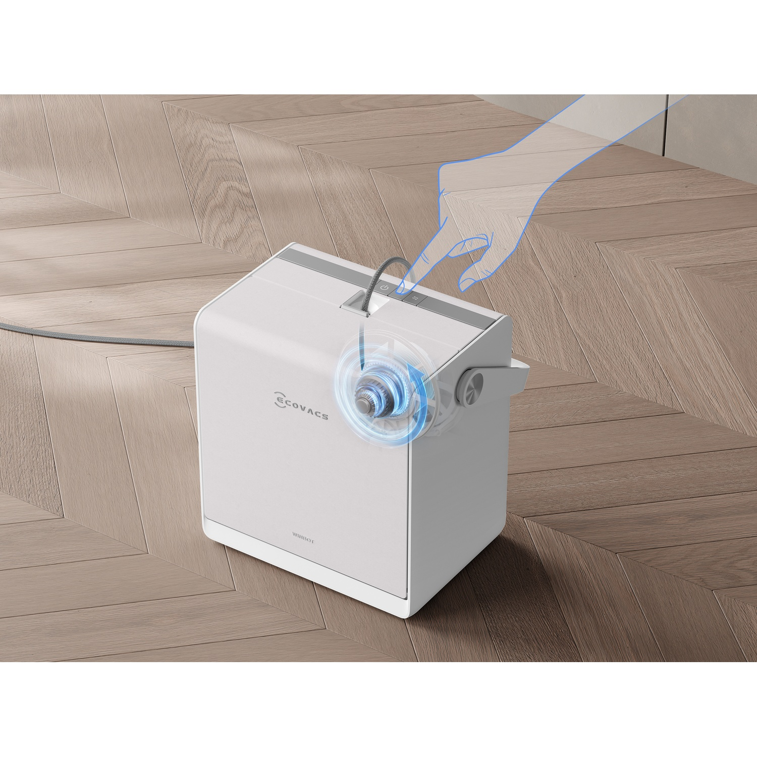 Una mano aziona un dispositivo bianco Ecovacs Winbot su un pavimento in legno.