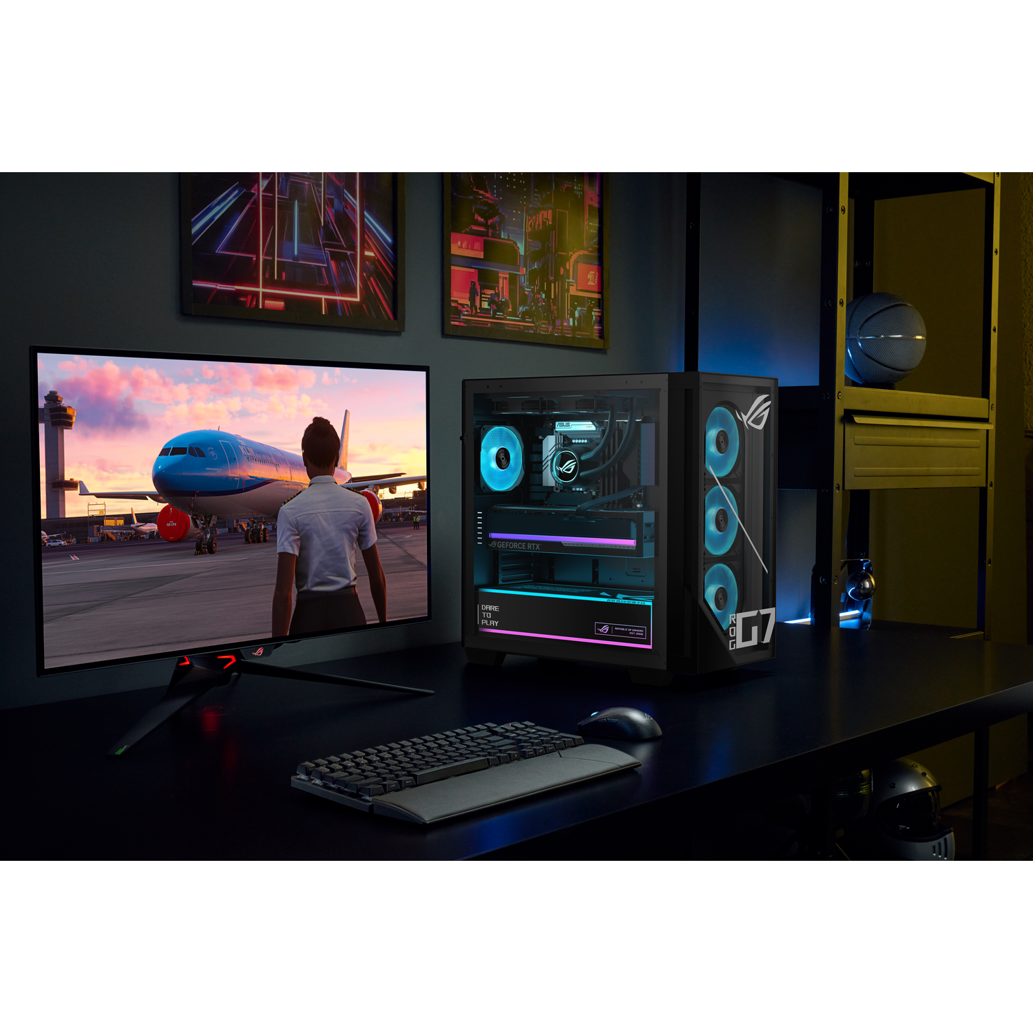 A gaming PC with blue lighting, monitor showing an airplane, keyboard, and mouse on a dark desk.