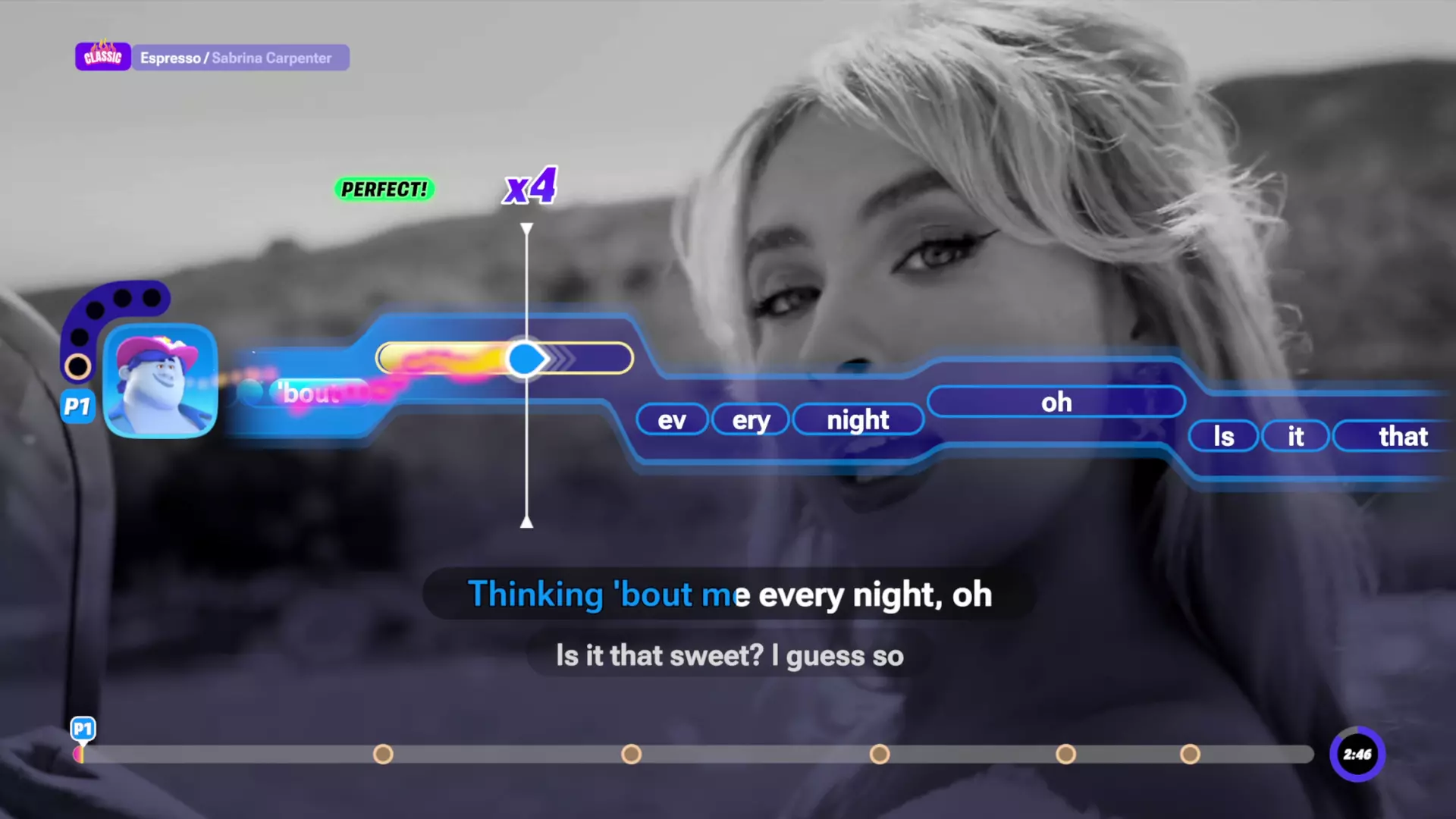 Una pantalla de karaoke de un videojuego muestra la letra de una canción y gráficos sobre una mujer rubia en un vídeo.