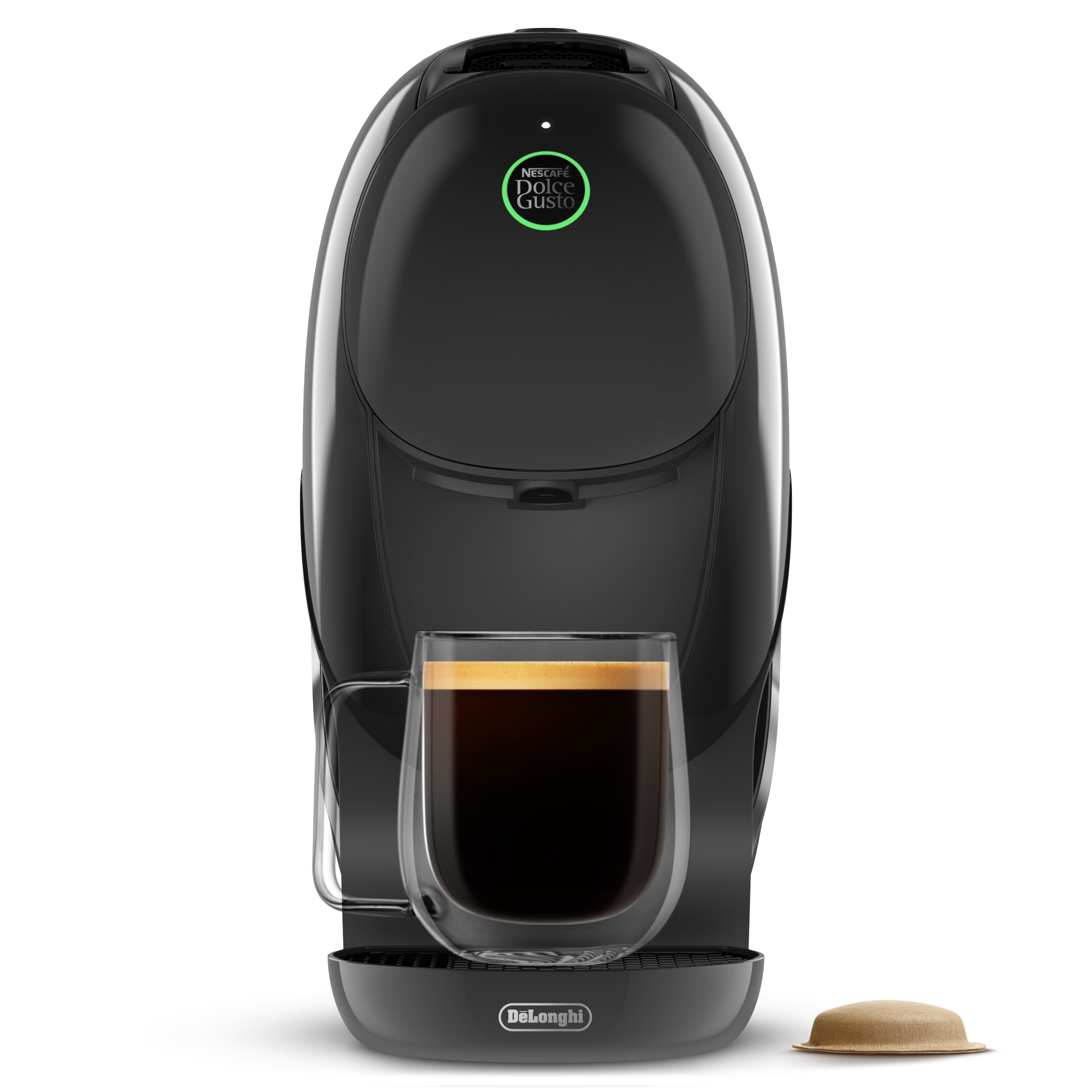 Cafetera negra DeLonghi Dolce Gusto con una taza de cristal de café y una cápsula sobre fondo negro.