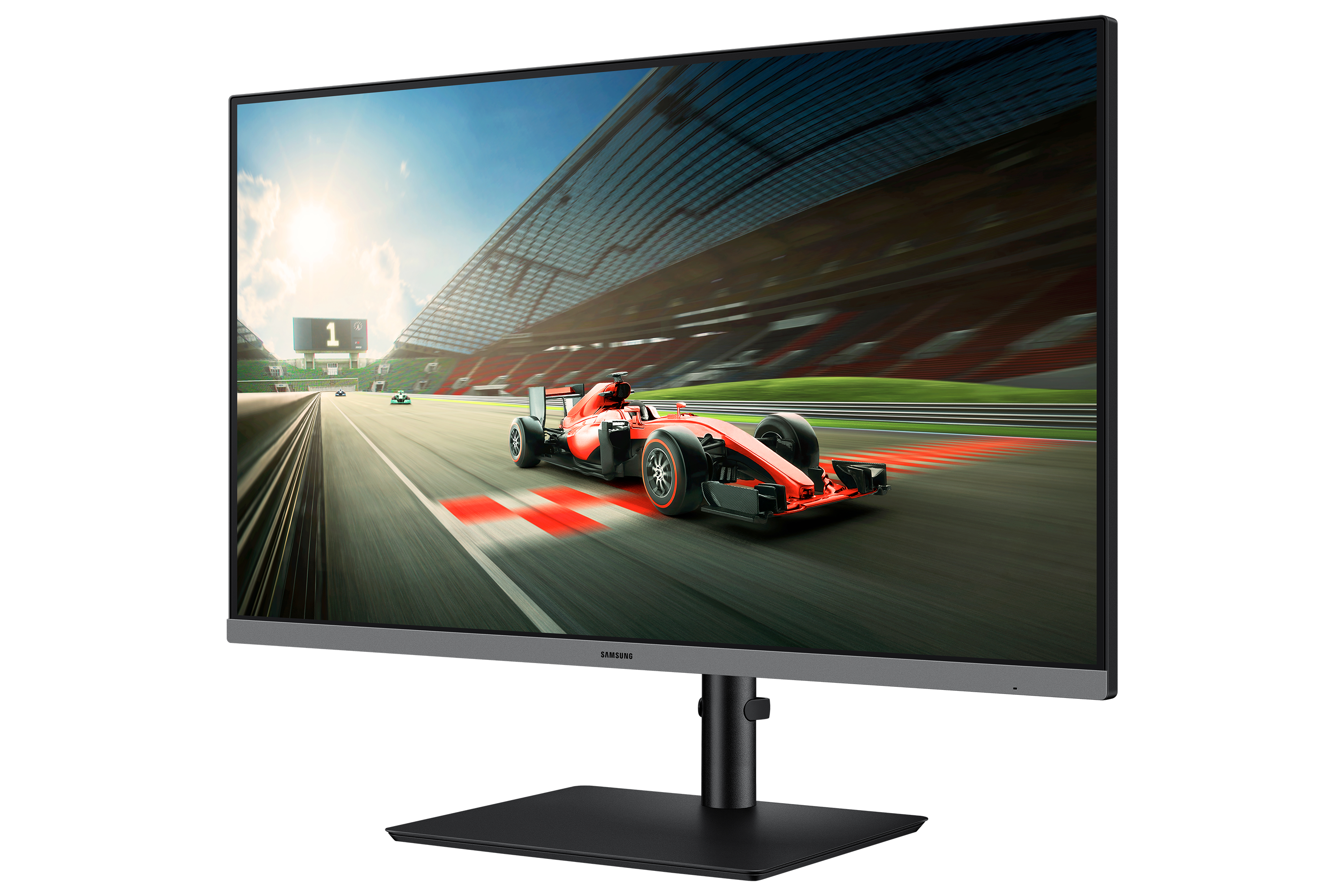A Samsung monitor displays a red race car driving on a track in front of a grandstand.