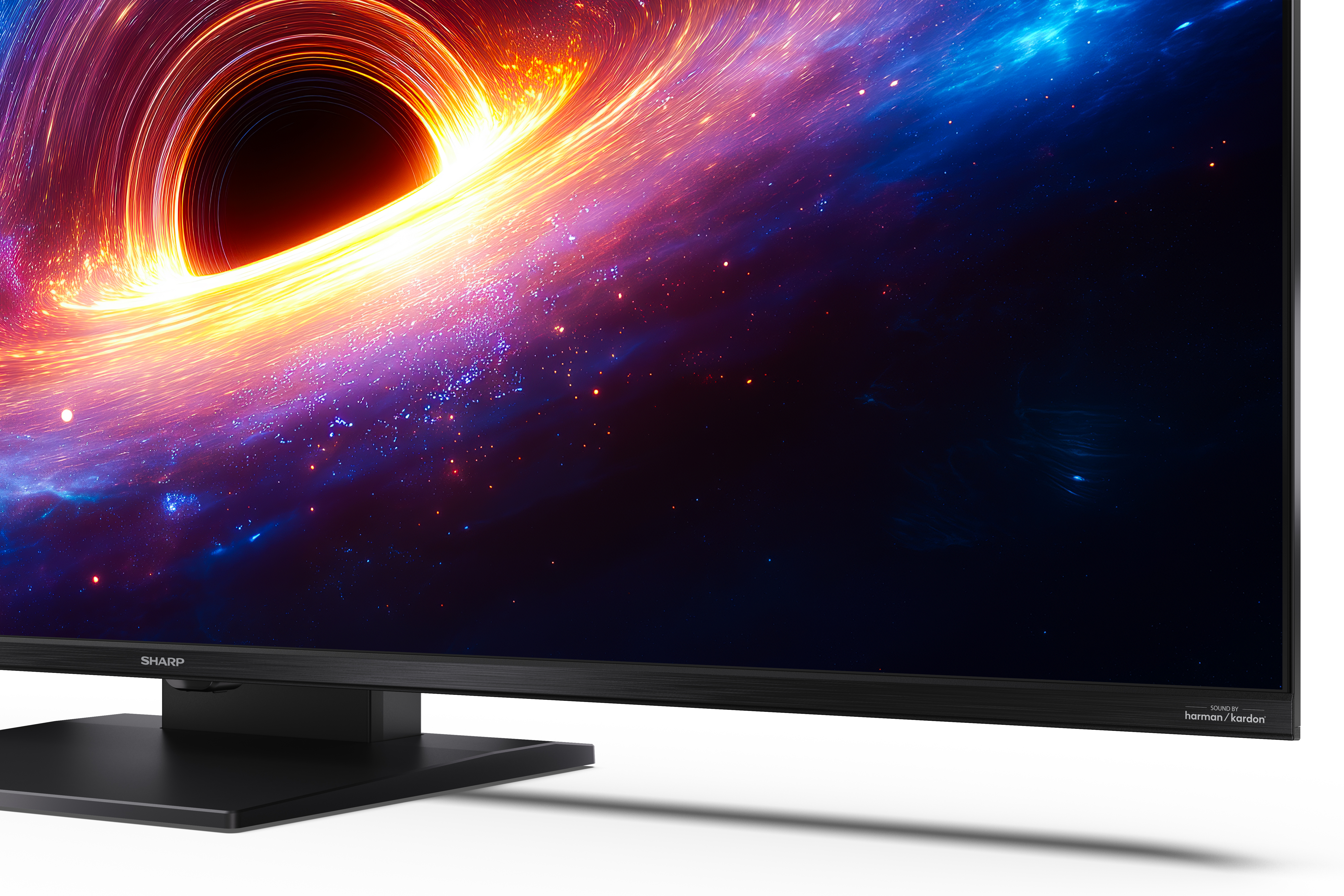 Telewizor Sharp z czarną podstawą wyświetla kolorową tapetę kosmiczną przedstawiającą czarną dziurę.