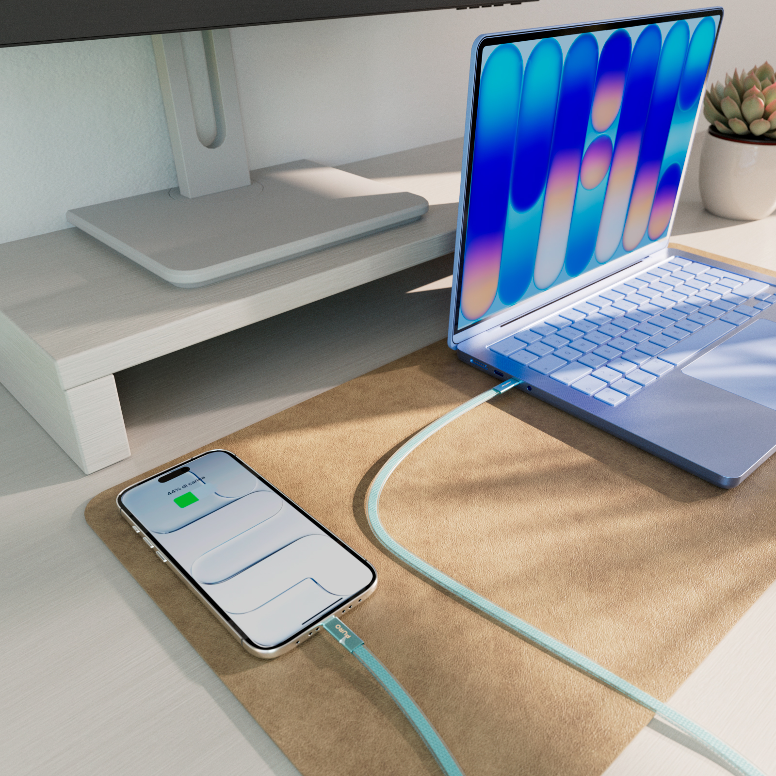 Ein Smartphone und ein Laptop auf einer Schreibtischunterlage, verbunden mit einem mintgrünen Kabel.