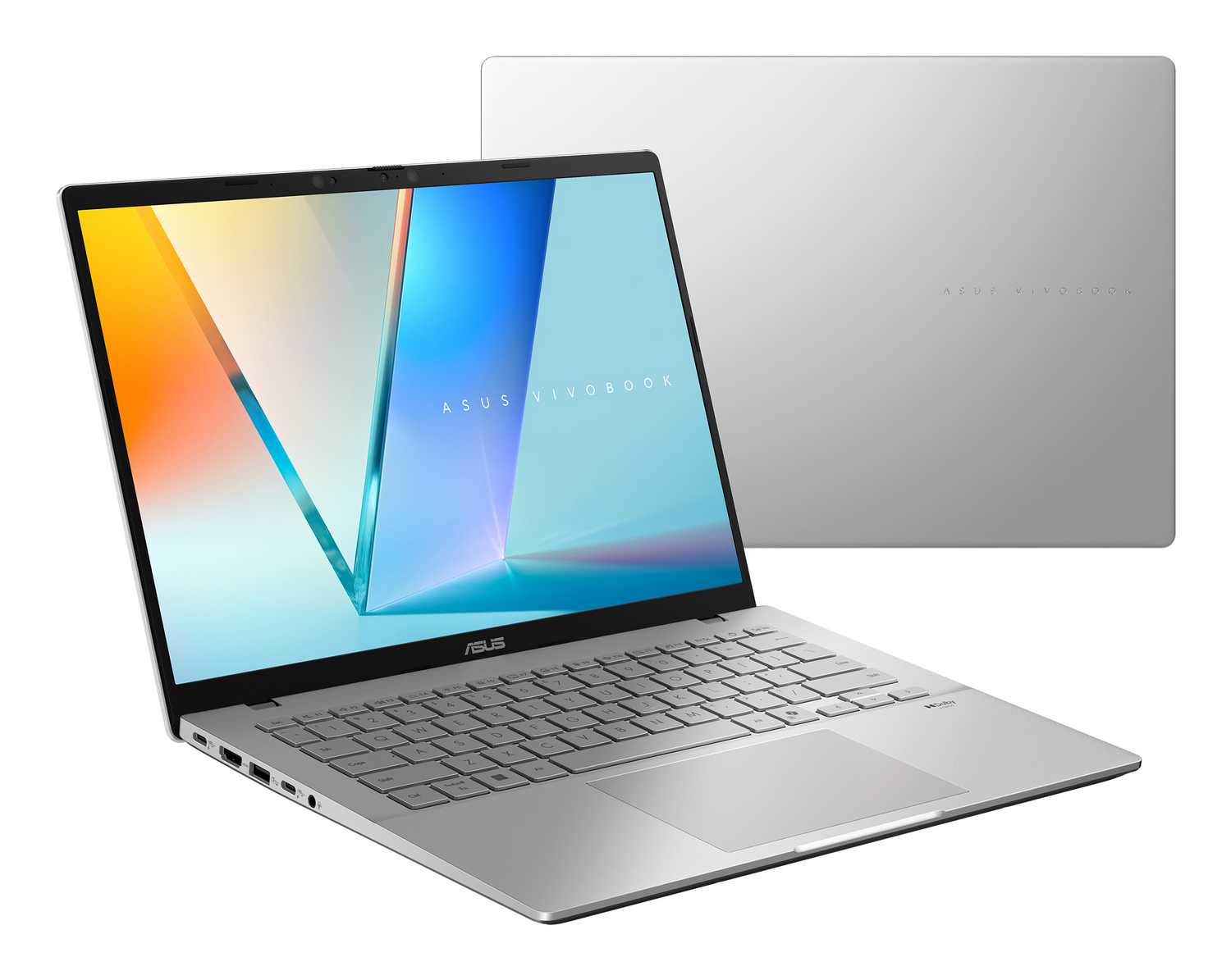 Se muestra un portátil Asus Vivobook plateado con la pantalla encendida y su tapa cerrada al fondo.