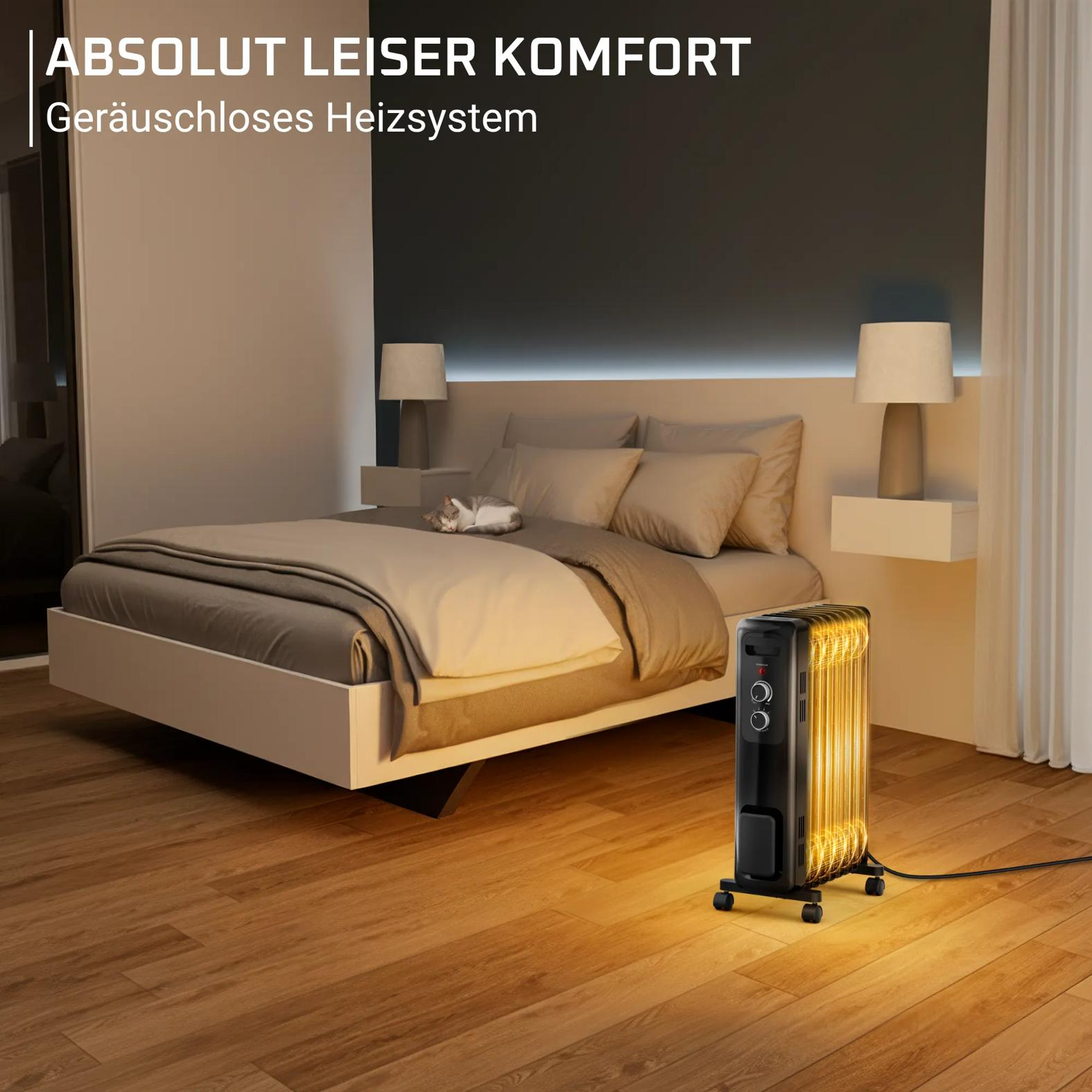 Ein schwarzer Ölradiator steht auf einem Holzfußboden in einem gemütlichen Schlafzimmer.