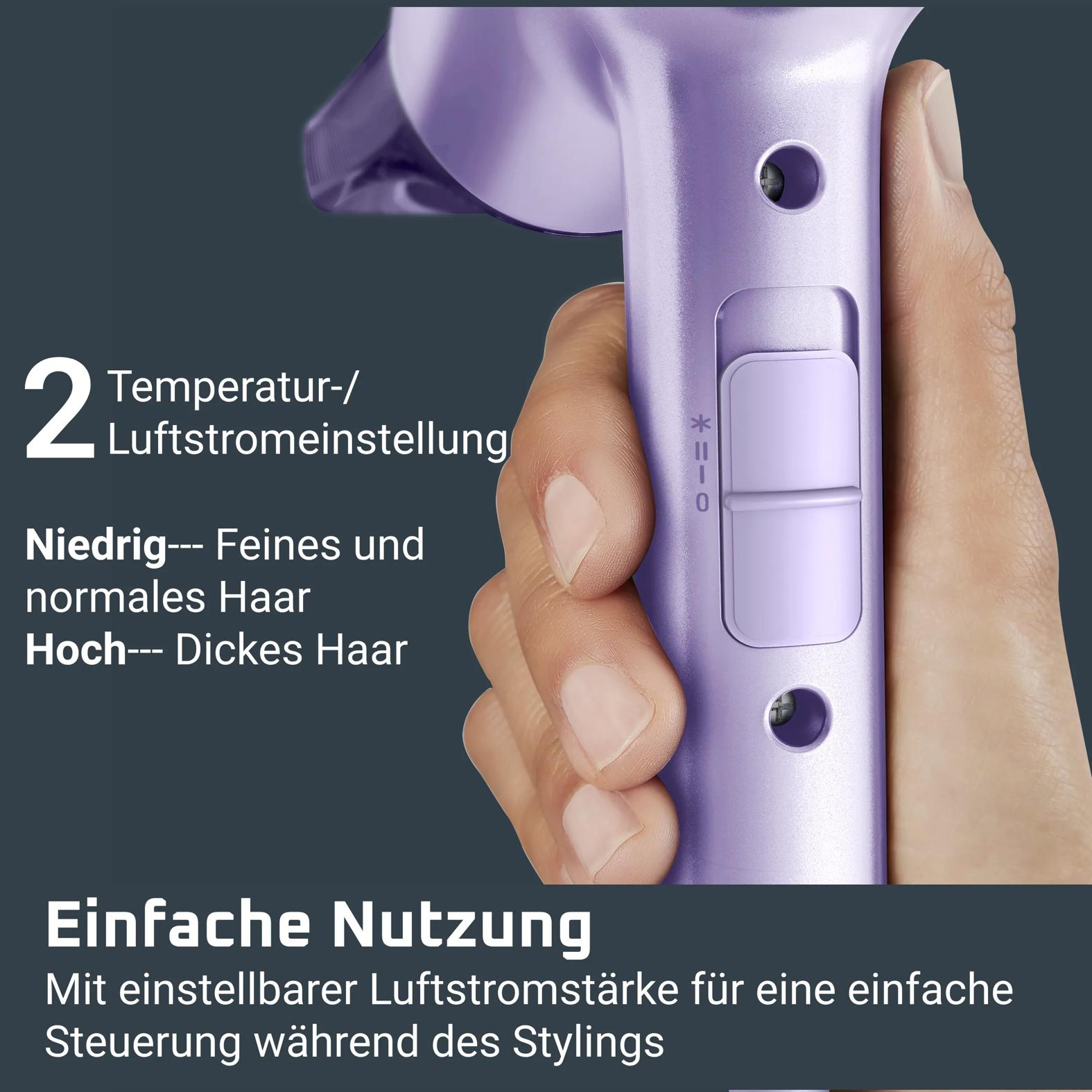 Hand hält einen violetten Haartrockner mit Schalter für zwei Temperatur- und Luftstromeinstellungen.