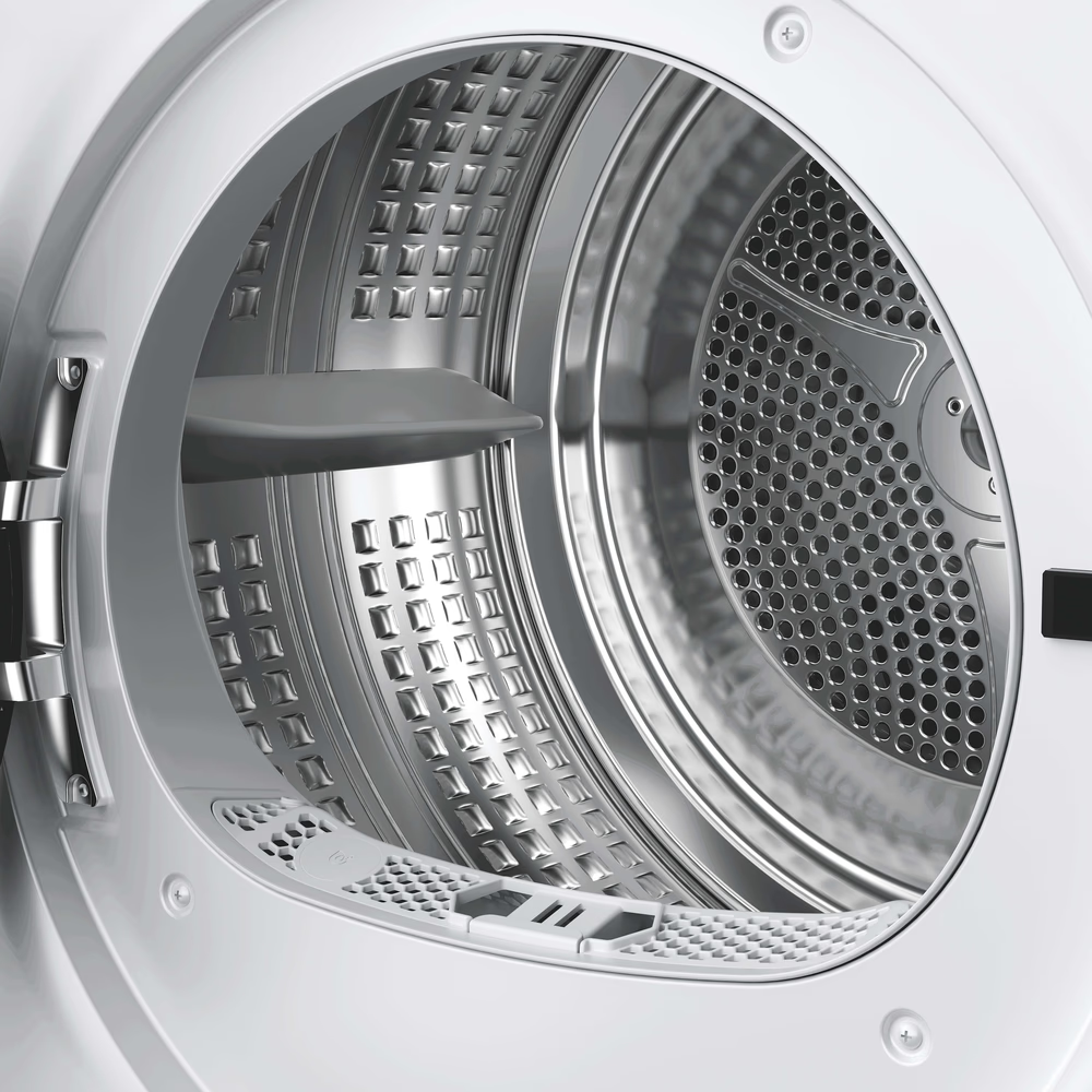 L'intérieur d'un tambour de sèche-linge propre en acier inoxydable argenté.