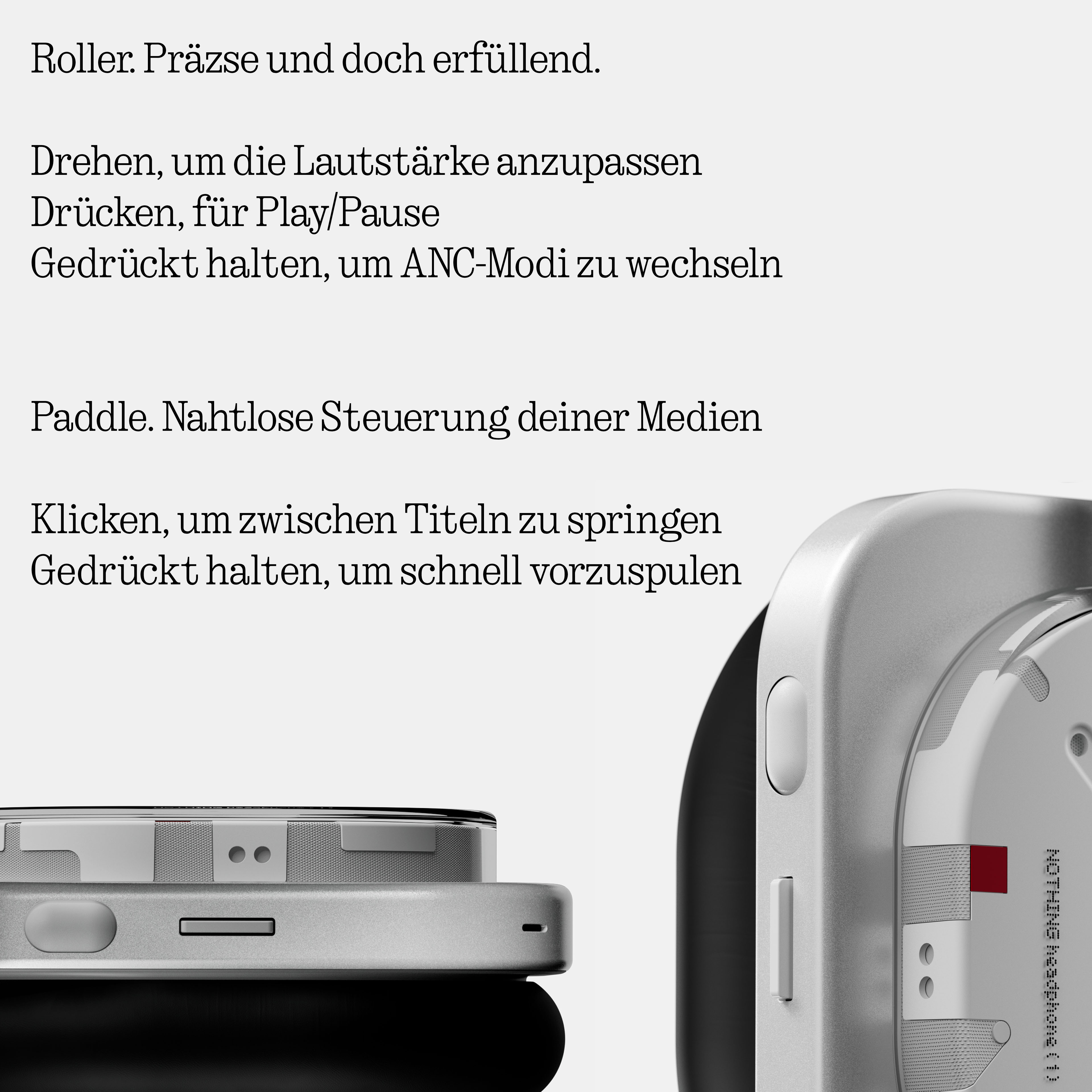 Nahaufnahme silberner Kopfhörer mit Steuertasten und deutschem Text zu ihren Funktionen.