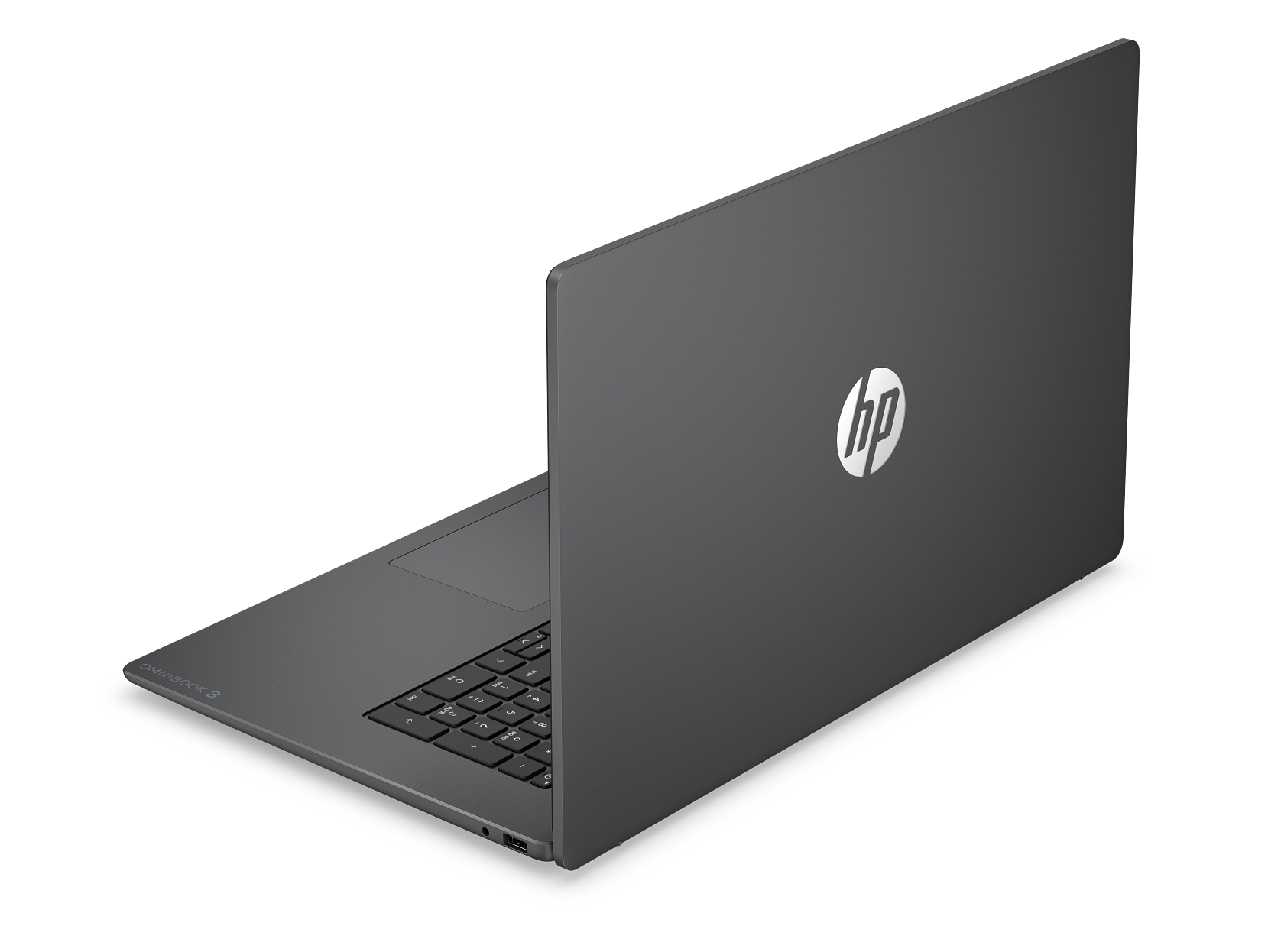 Szary laptop HP na czarnym tle, z widocznym logo HP na zamkniętej klapie.