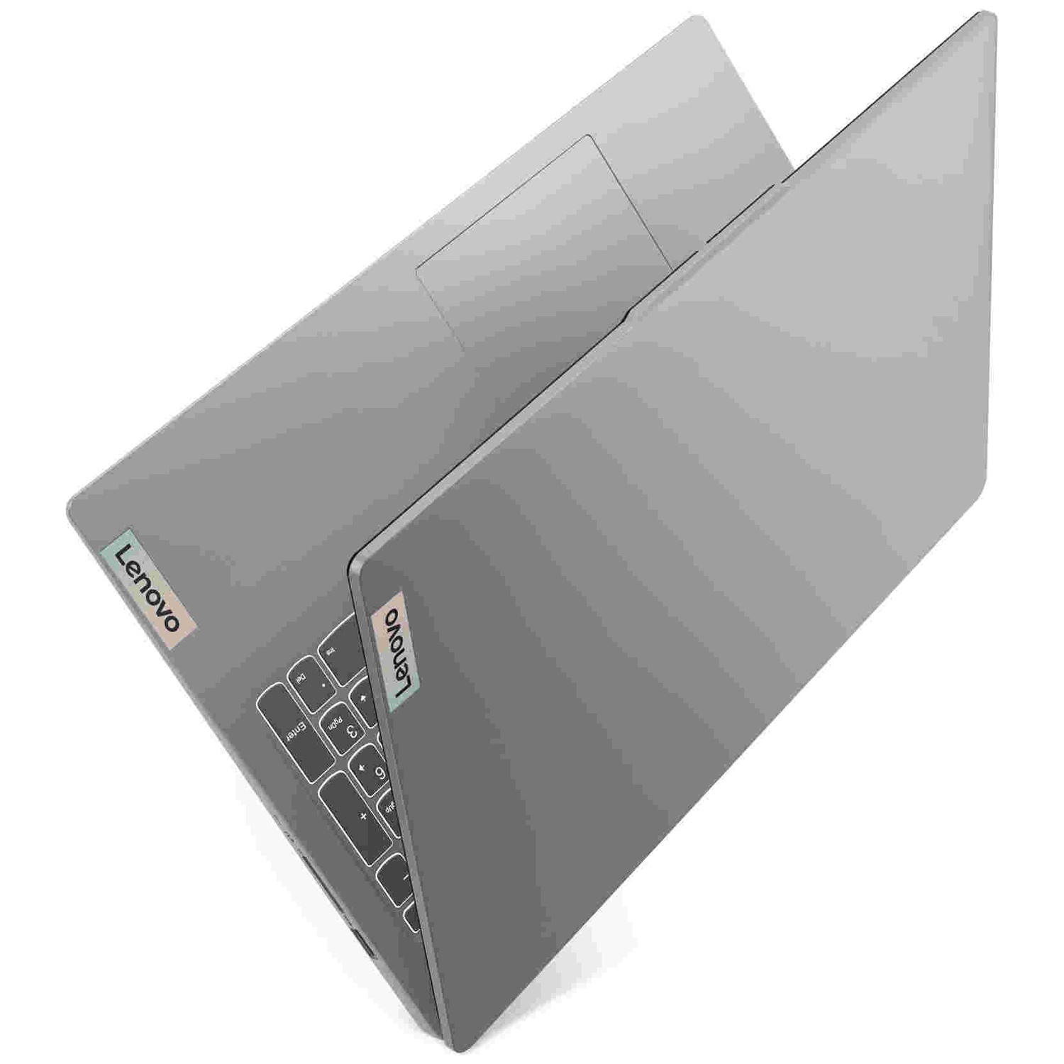 Un ordinateur portable Lenovo argenté ouvert sur fond blanc, avec clavier, pavé tactile et logos.