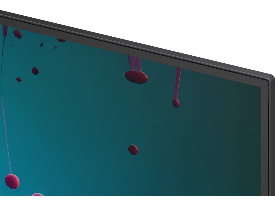 Primer plano de un monitor negro elegante que muestra una pantalla azul con gotas rosas.
