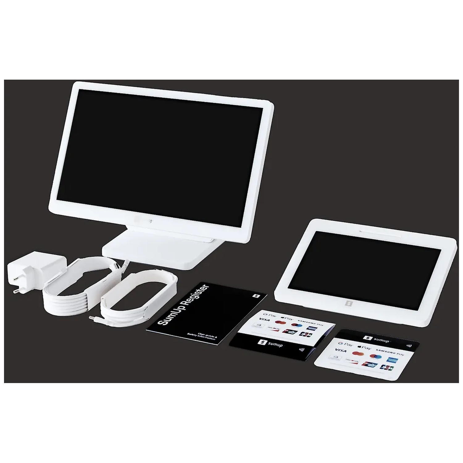 A white POS system with monitor, customer display, cables, power supply, and manuals on a dark background.
