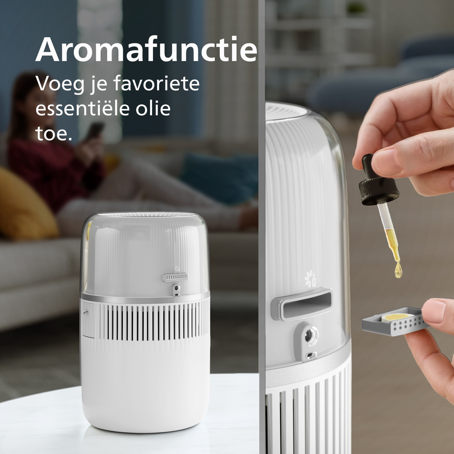 Een hand druppelt essentiële olie op een pad voor een witte luchtreiniger.