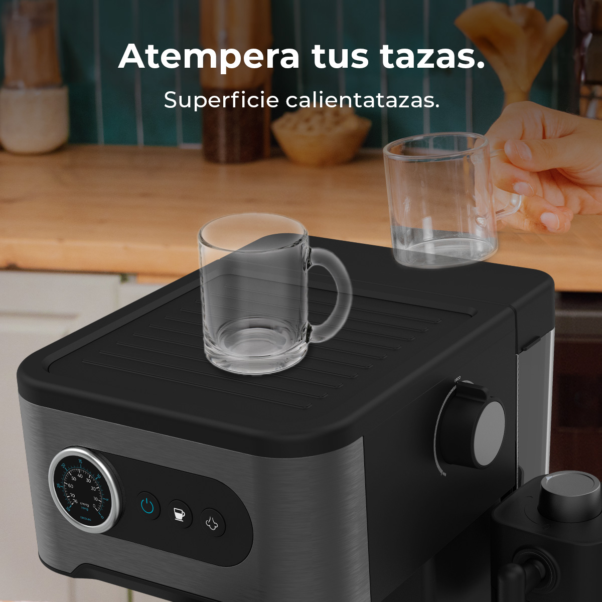 Una cafetera con una taza en la superficie calientatazas y una mano sosteniendo otra taza.
