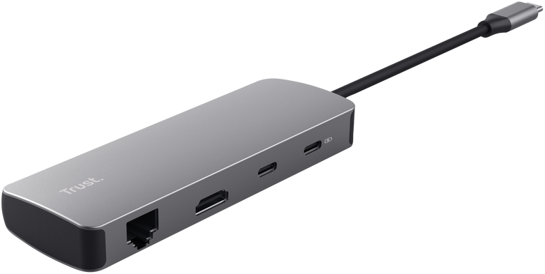 Grauer Trust USB-C Multiport-Hub mit Ethernet-, HDMI- und USB-Anschlüssen vor schwarzem Hintergrund.