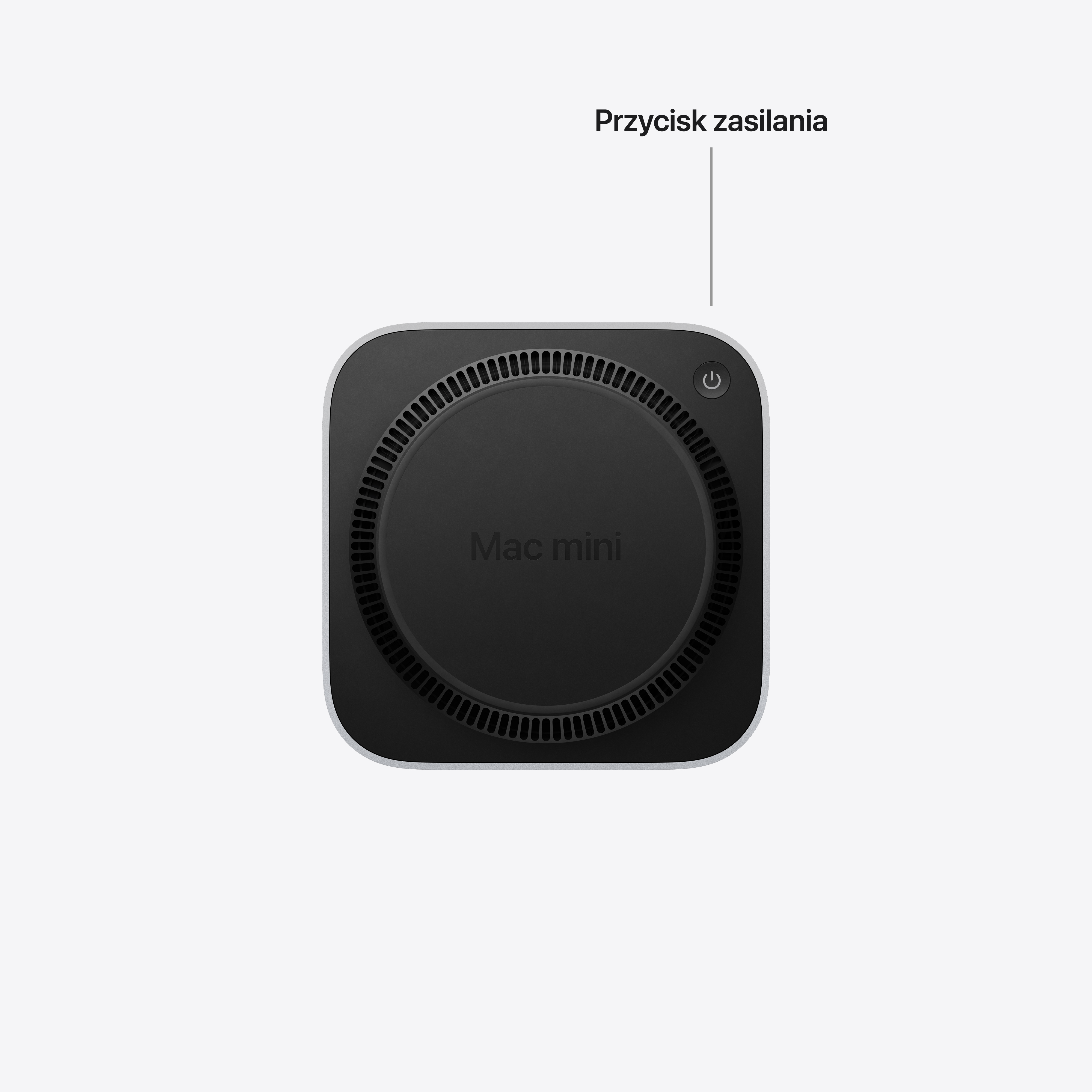 Widok od dołu komputera Mac mini na białym tle, wskazujący przycisk zasilania.