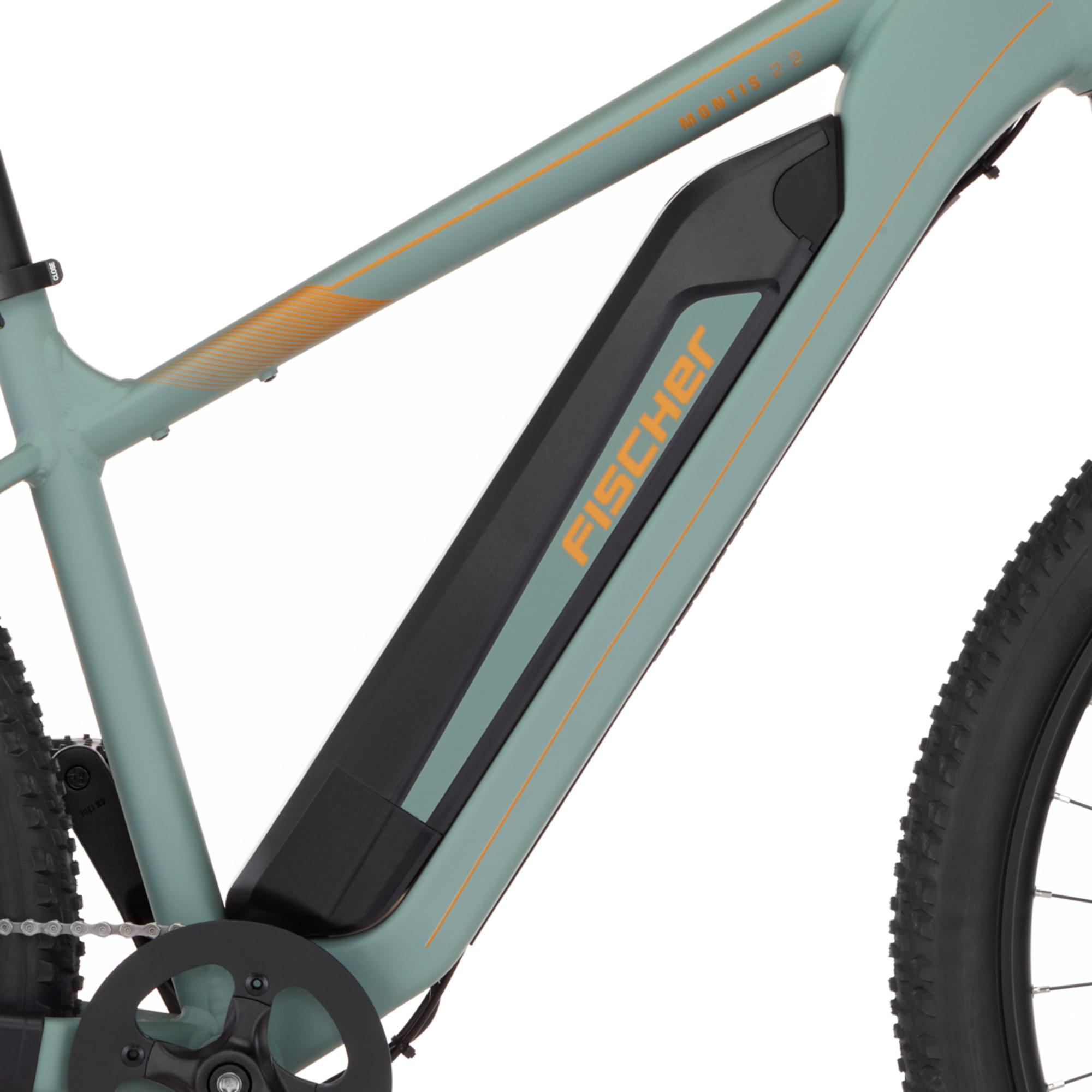 Grünes Fischer E-Bike Rahmendetail mit integriertem Akku, Kurbel und Profilreifen.