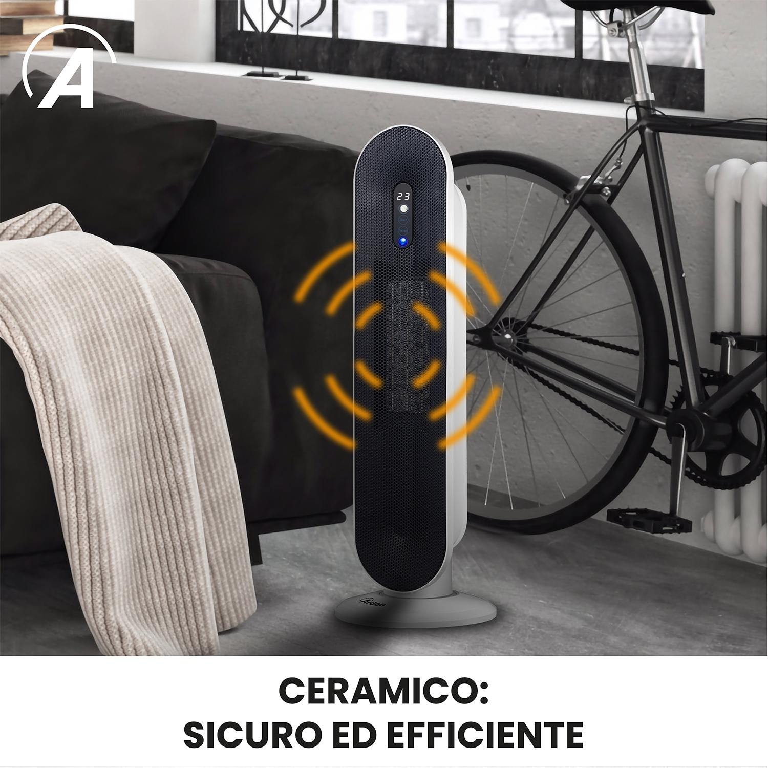 Una stufa a torre nera e argento è posata su un pavimento di legno accanto a un divano e a una bicicletta.