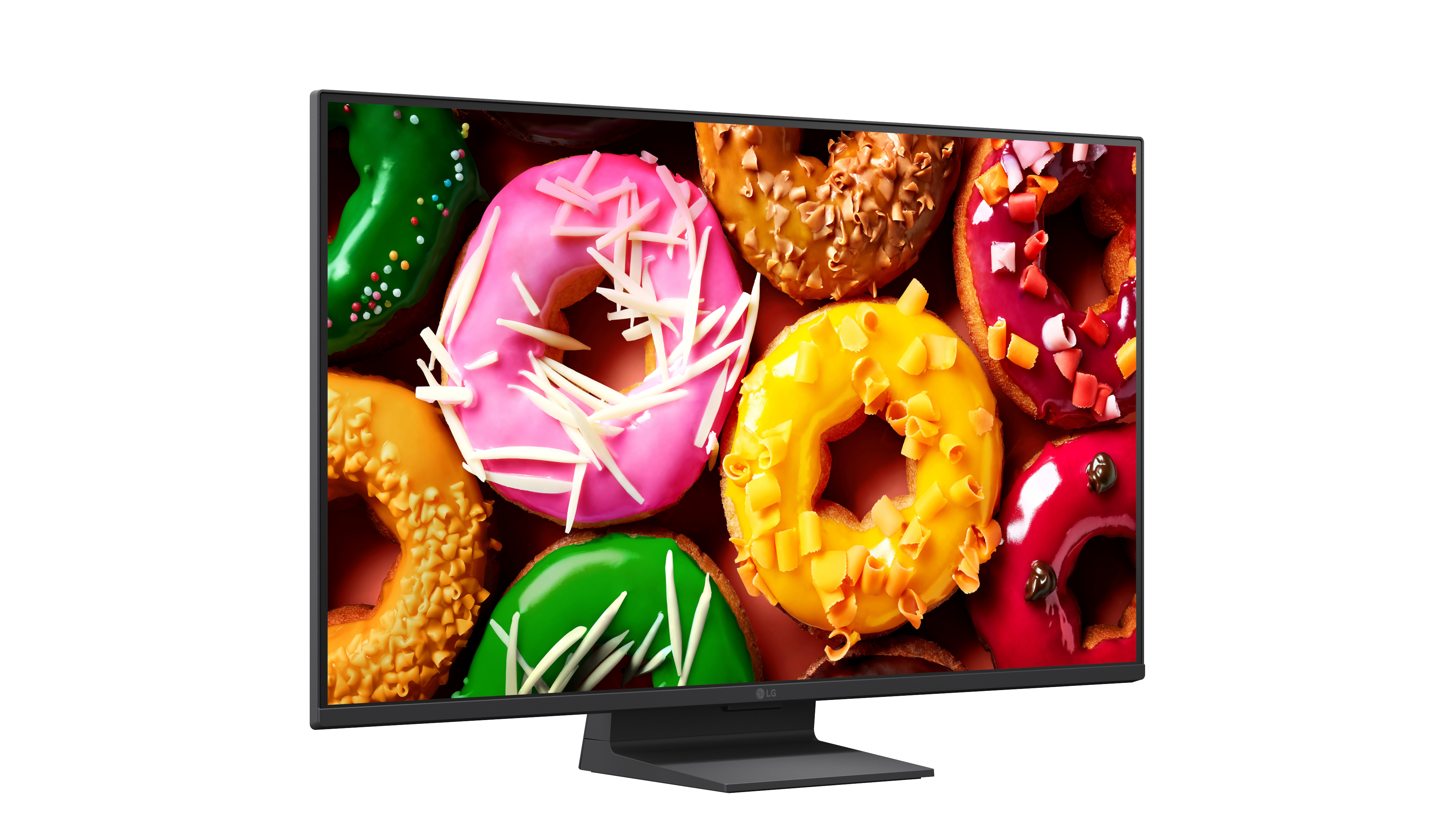 Egy modern LG monitor képernyőjén különféle mázas fánkok színes gyűjteménye látható.