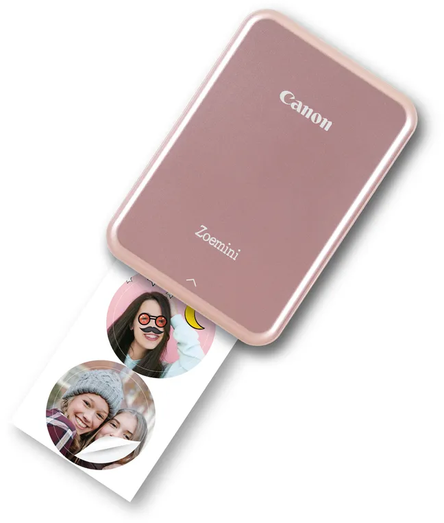 Ein rosafarbener Canon Zoemini Fotodrucker druckt ein Foto mit zwei runden Bildern von lächelnden jungen Frauen.
