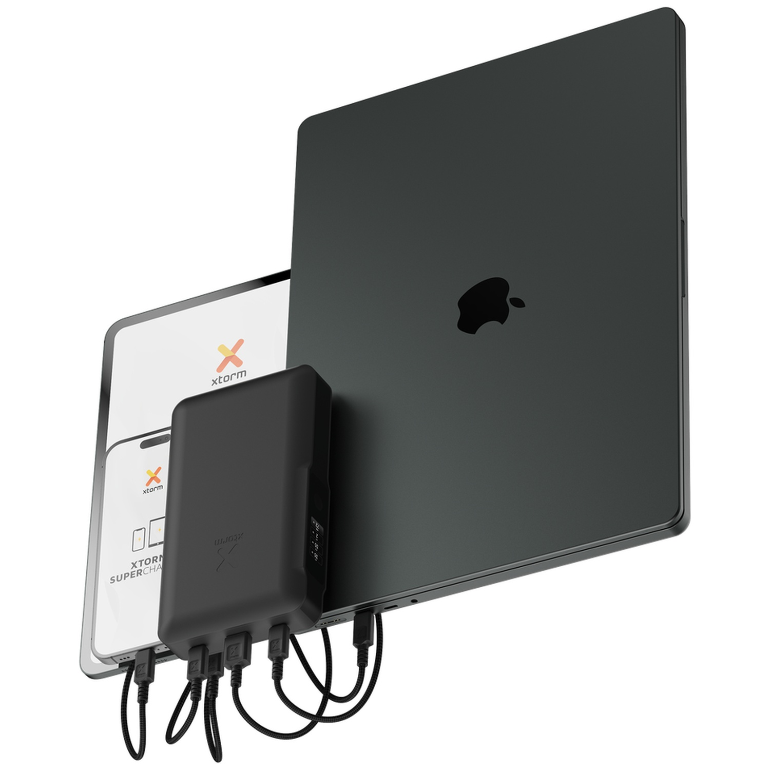 Une batterie externe noire avec des câbles connectés charge un ordinateur portable, une tablette et un smartphone.