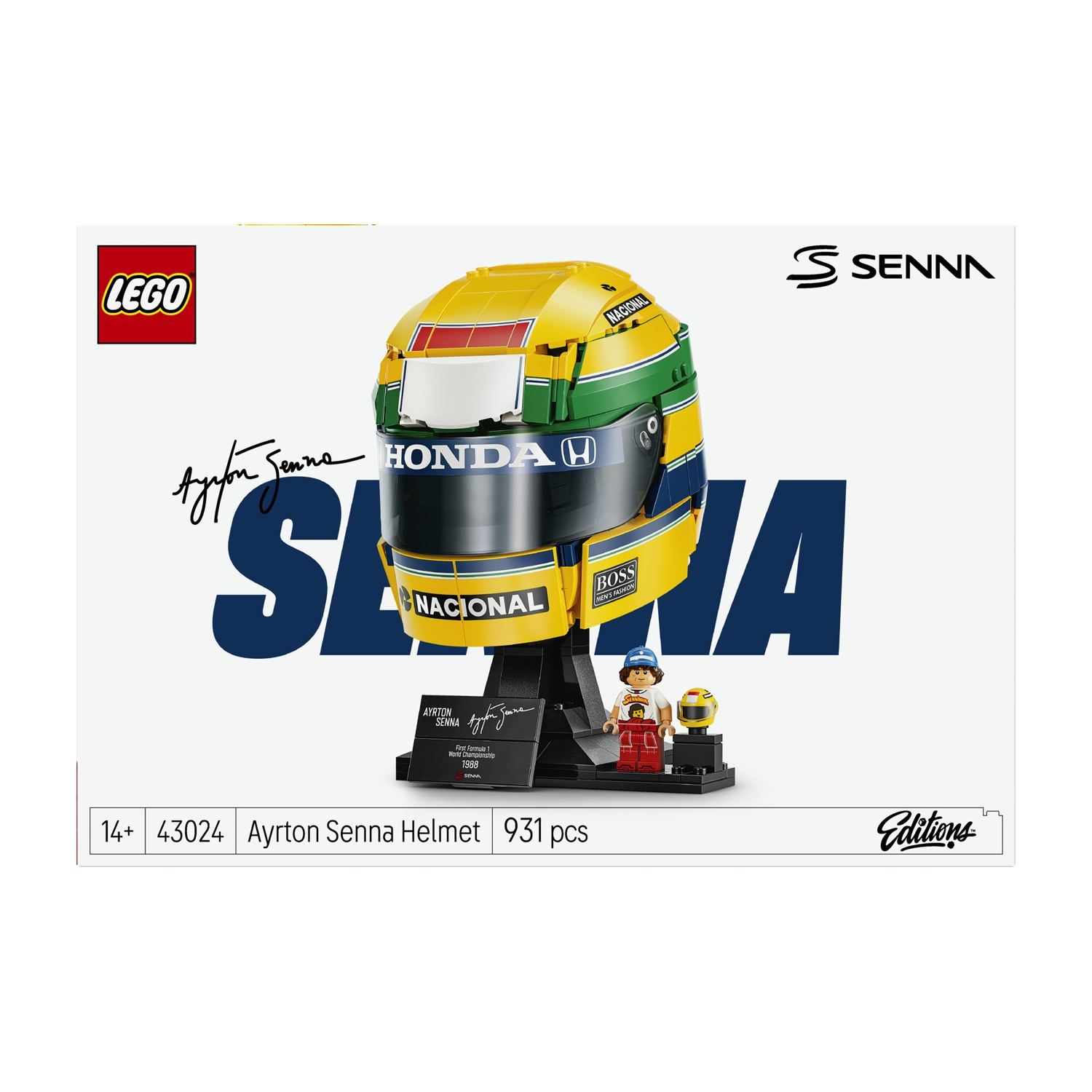 Set casco Lego Ayrton Senna con supporto, minifigure e casco piccolo su sfondo bianco.