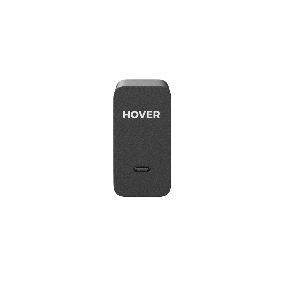 Ein schwarzes Hover-Ladegerät mit abgerundeten Ecken und einem USB-C-Anschluss auf einer weißen Oberfläche.