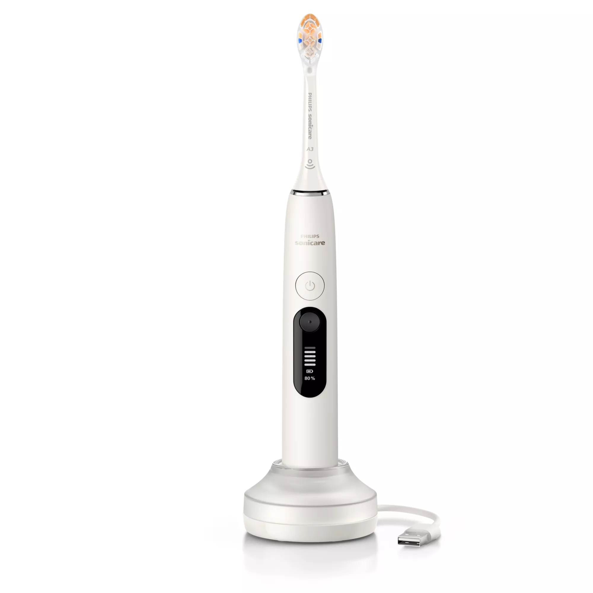 Biała elektryczna szczoteczka do zębów Philips Sonicare stoi na białej podstawce ładującej z kablem USB.
