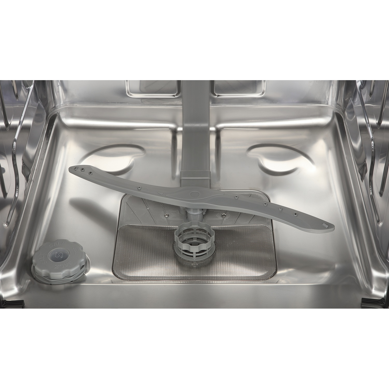 The interior of an empty stainless steel dishwasher showing a gray spray arm, filter, and salt container.